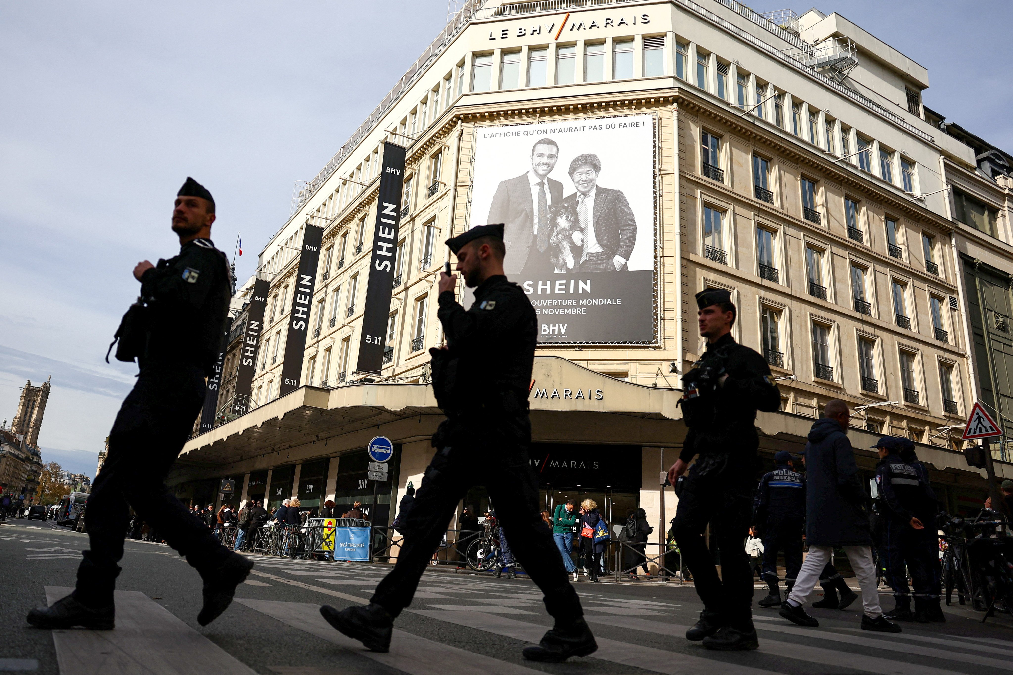 French police walk past the BHV Marais department store in Paris on November 5, 2025, the day of the opening of Chinese online fast-fashion retailer Shein’s first physical store inside BHV. Photo: Reuters