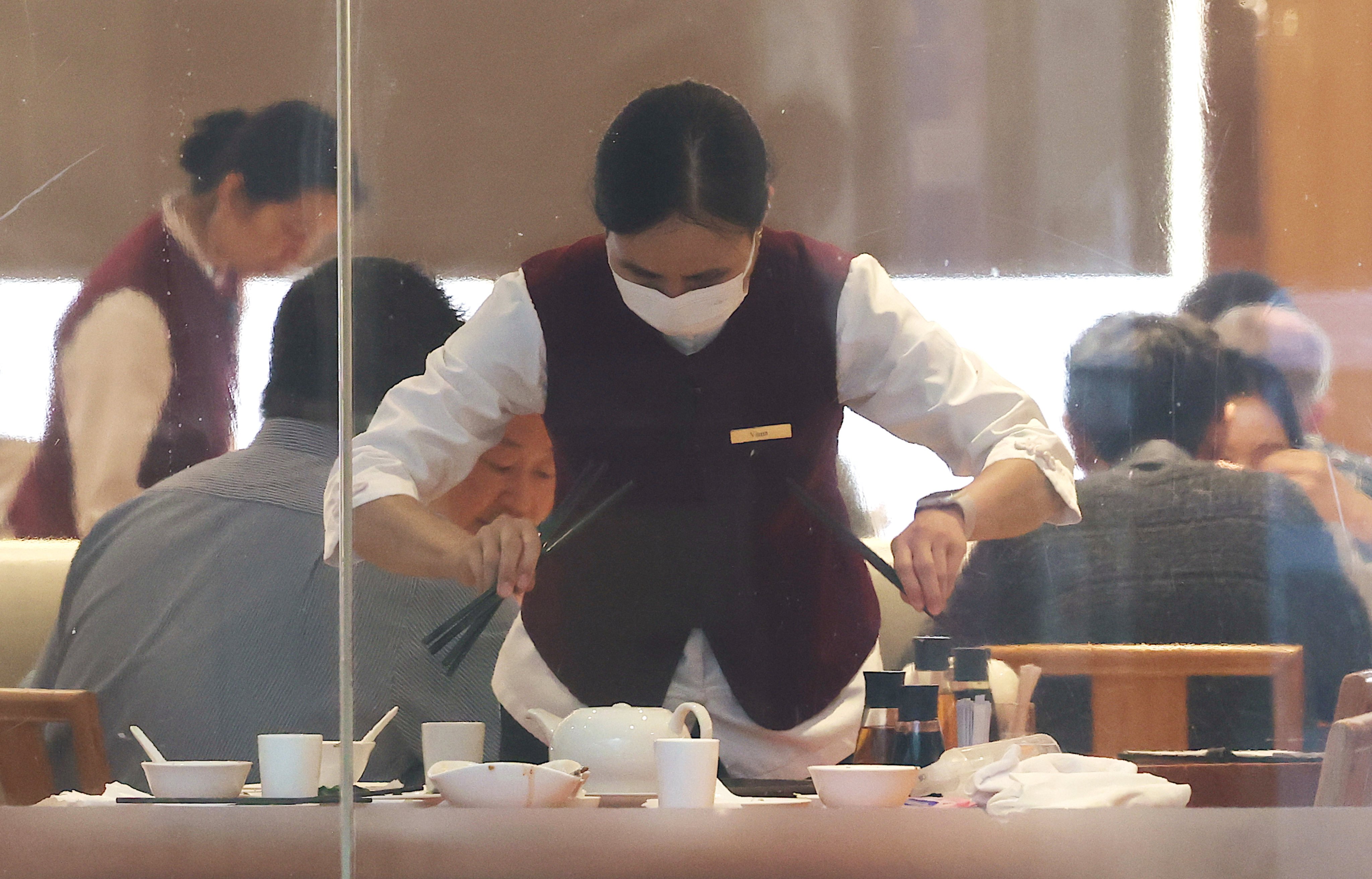 Workers at a restaurant in Tsim Sha Tsui. As of May, the scheme had approved more than 17,000 applications involving nearly 110,000 workers, about 40 per cent of whom were employed in the food and beverage services industry. Photo: Jelly Tse