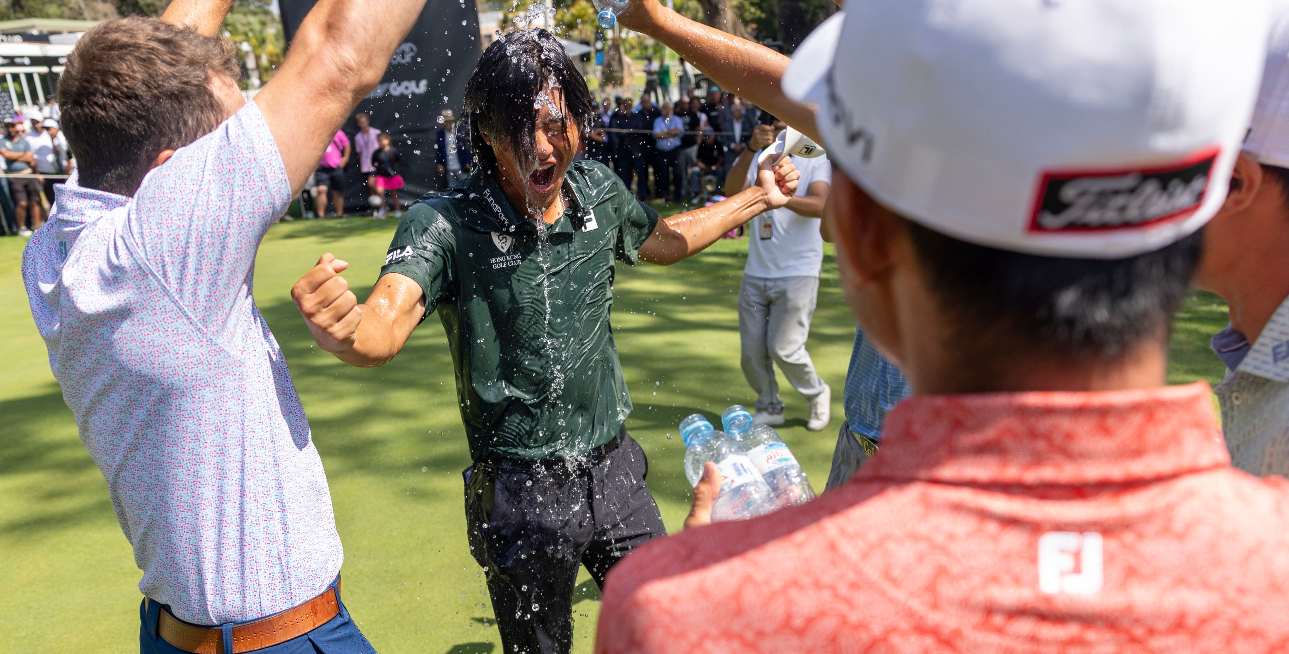 Taichi Kho gets the traditional soaking on the 18th green after winning in Morocco. Photo: Asian Tour