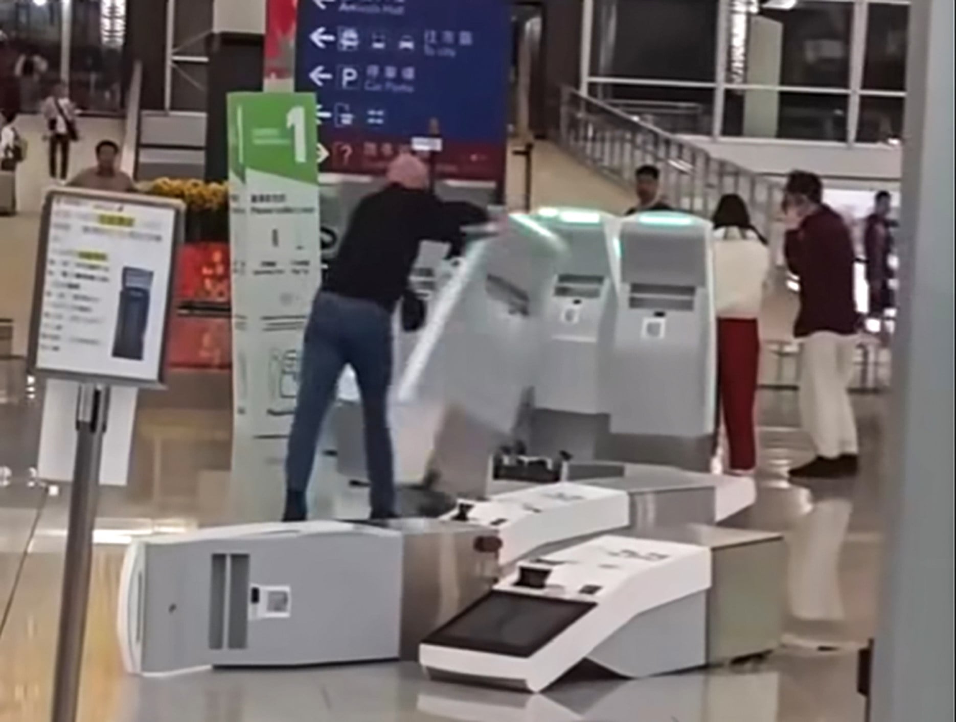 A screengrab of the viral video shows Youcef Bennoui knocking down check-in kiosks at Hong Kong International Airport on February 16. Photo: Facebook/hkcaml