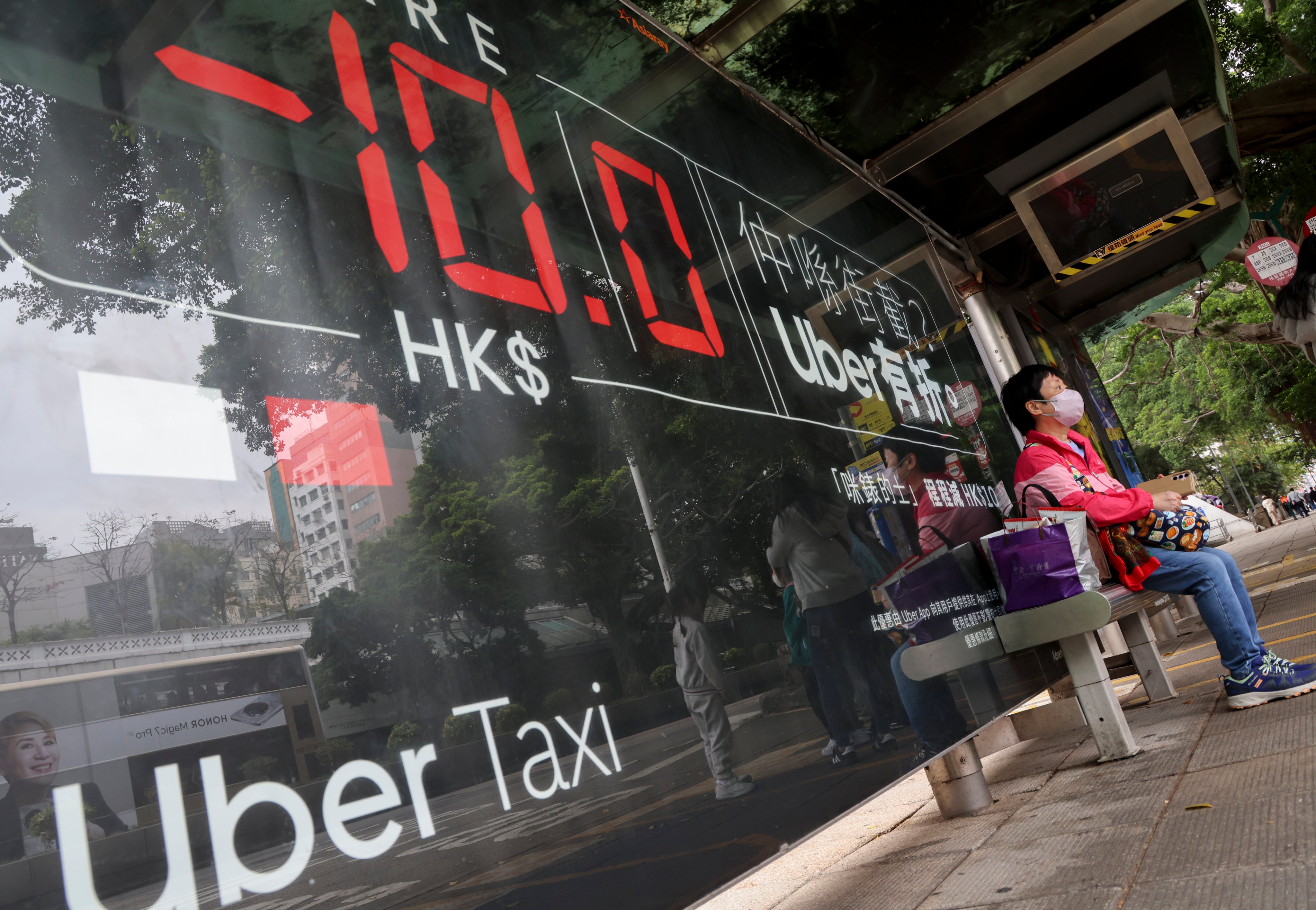 An Uber Taxi advertising board in Tsim Sha Tsui. The proposed 10,000-permit cap for ride-hailing vehicles would be shared among operators such as Uber, Tada, Didi and Amap. Photo: Jelly Tse