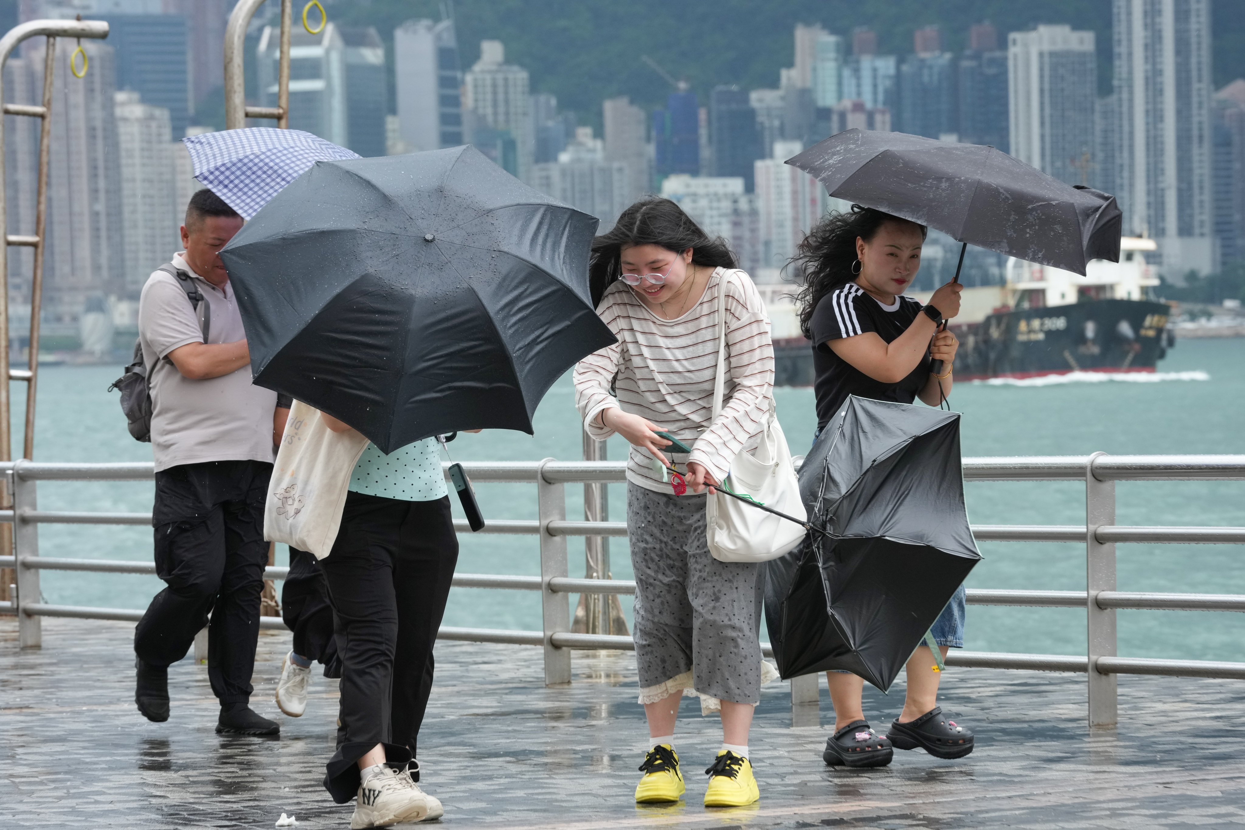 Tourists brave stormy weather at the Tsim Sha Tsui waterfront. Photo: Jelly Tse