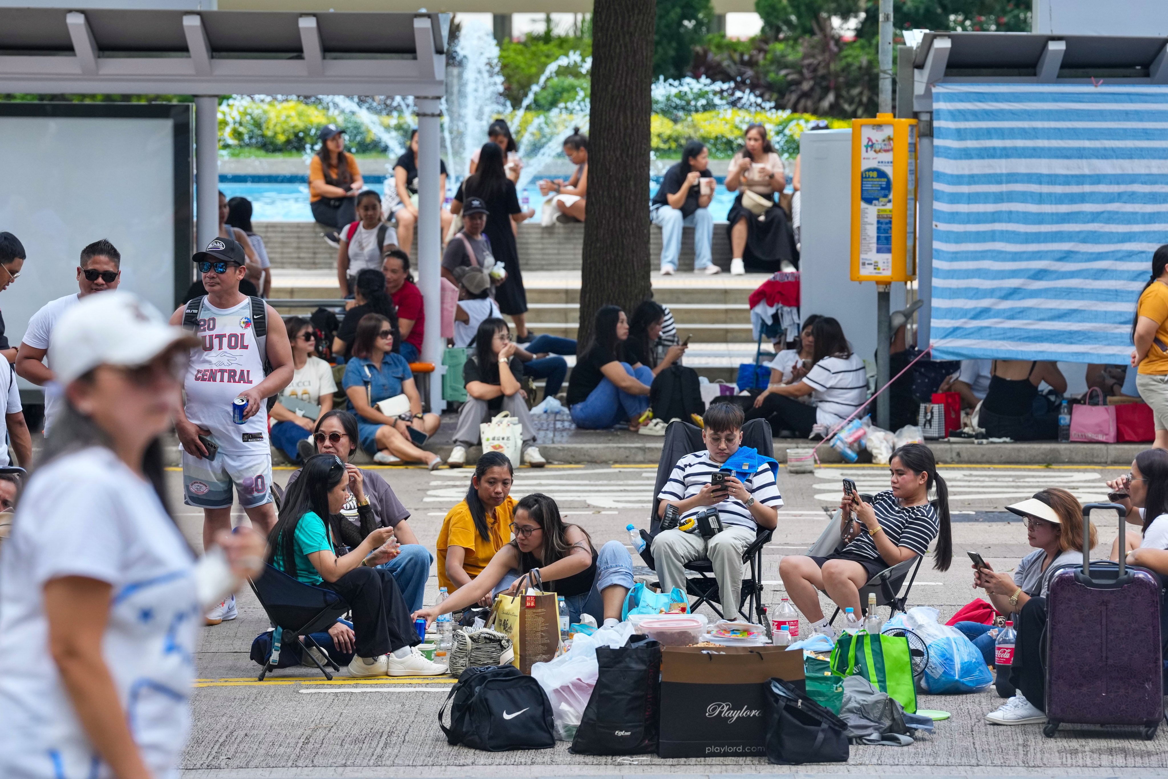 Domestic helpers gather in Central on their day off. A three-year lease for a new shelter for helpers in distress has been signed after the earlier site – a small three-bedroom flat in Kennedy Town – reached the end of its term. Photo: Karma Lo