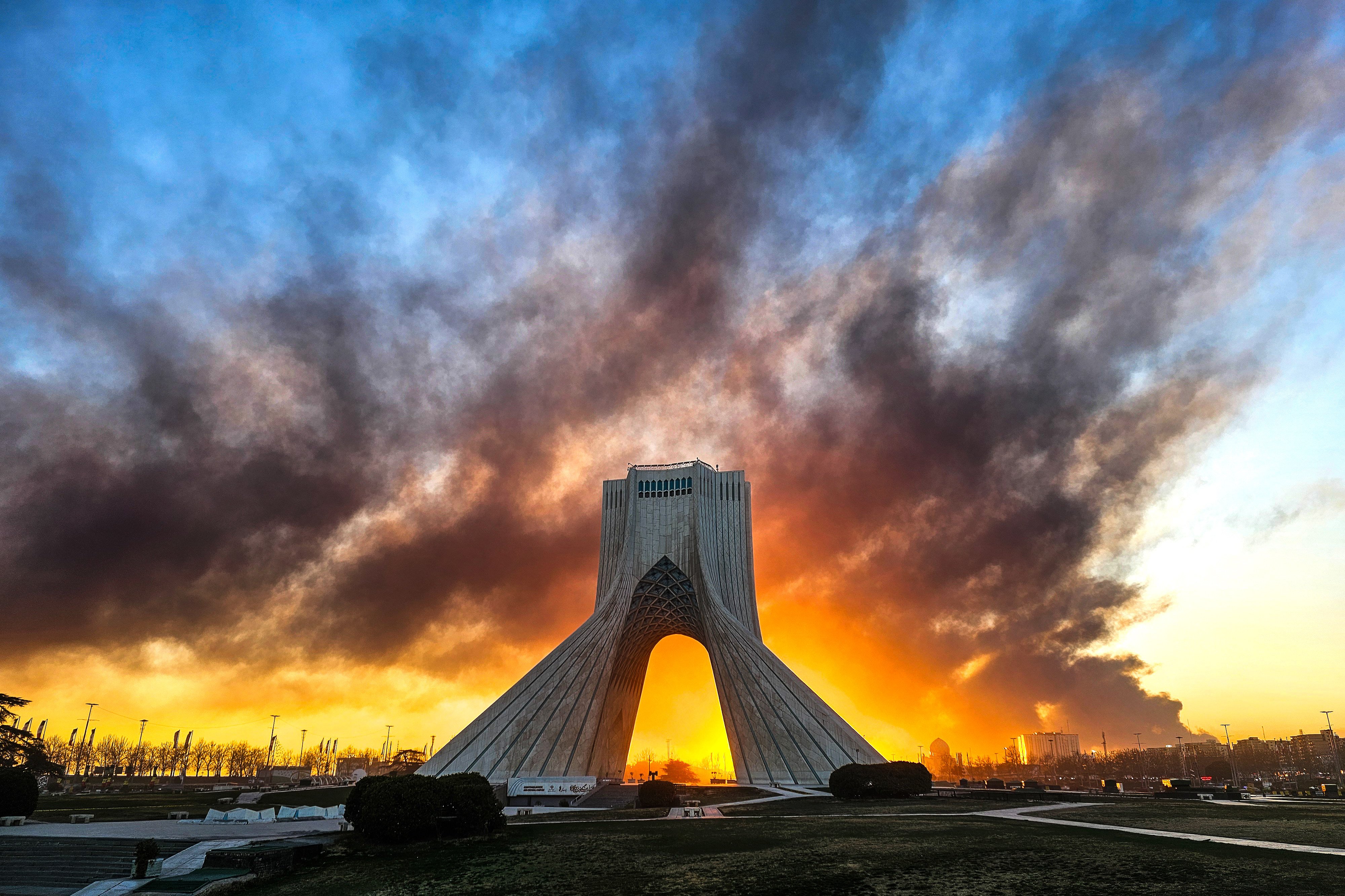 Smoke rises behind the Azadi Tower in Tehran following a US-Israeli military strike on Iran in early March. Photo: ISNA/AP