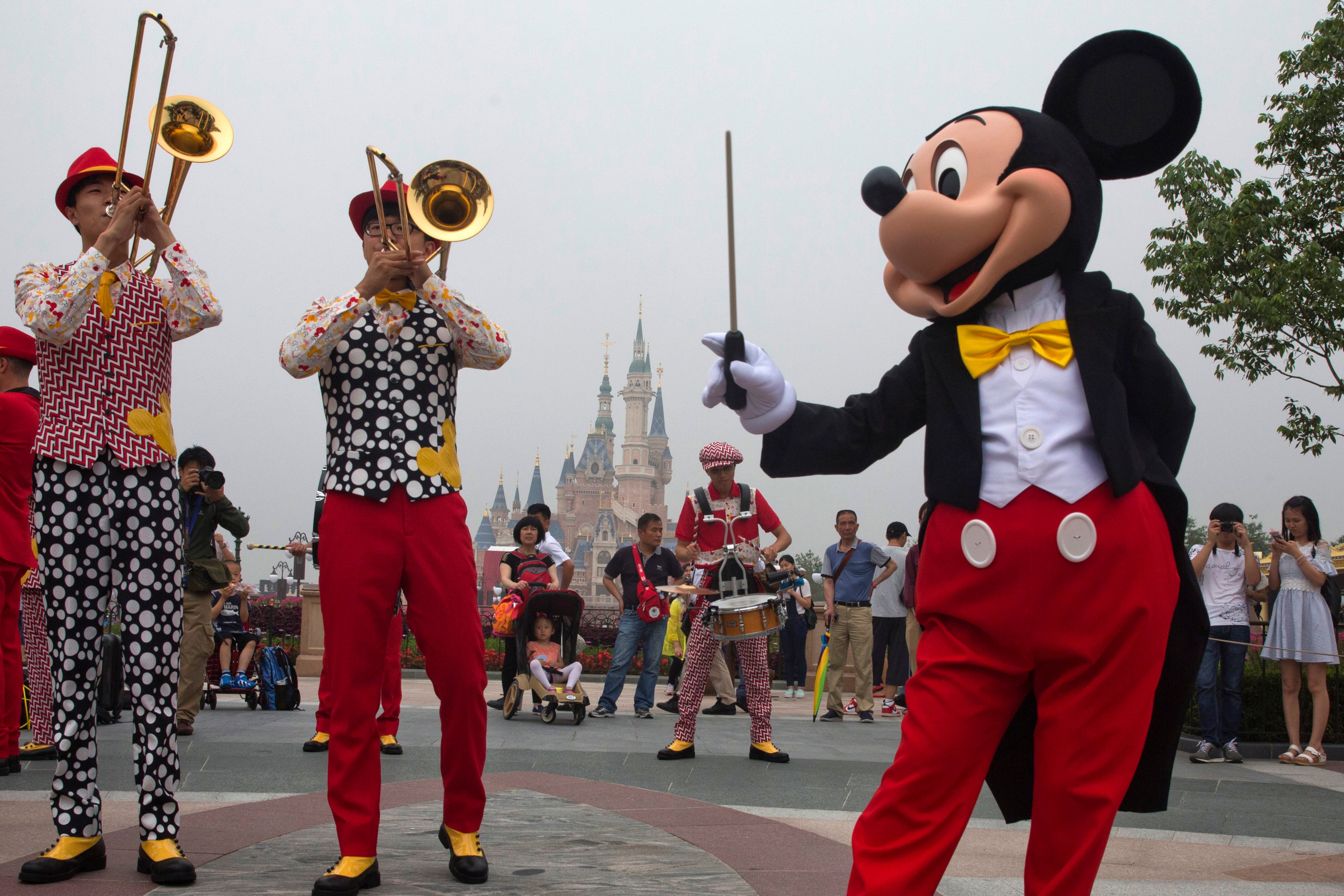Mickey Mouse entertains visitors at Shanghai’s Disneyland theme park on its opening day on June 16, 2016. Photo: AP