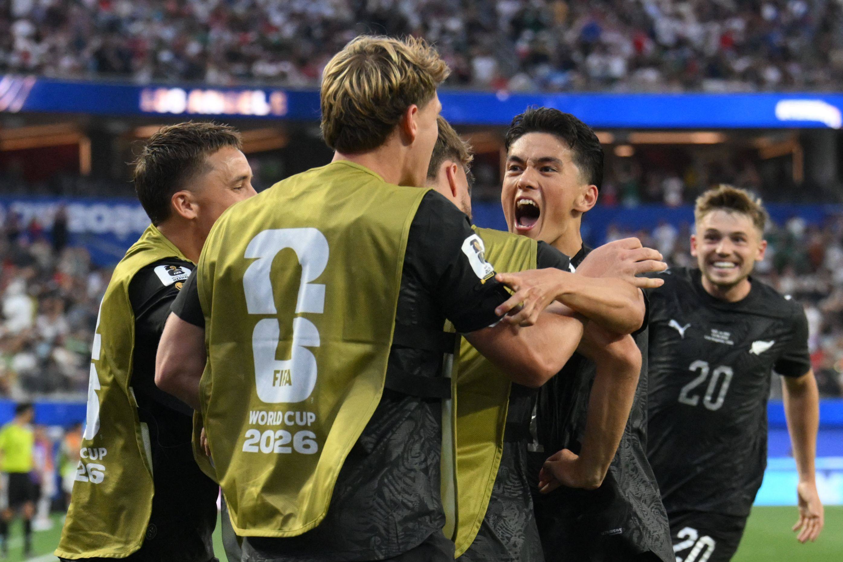New Zealand’s Elijah Just (right) celebrates with teammates after scoring his team’s second. Photo: AFP