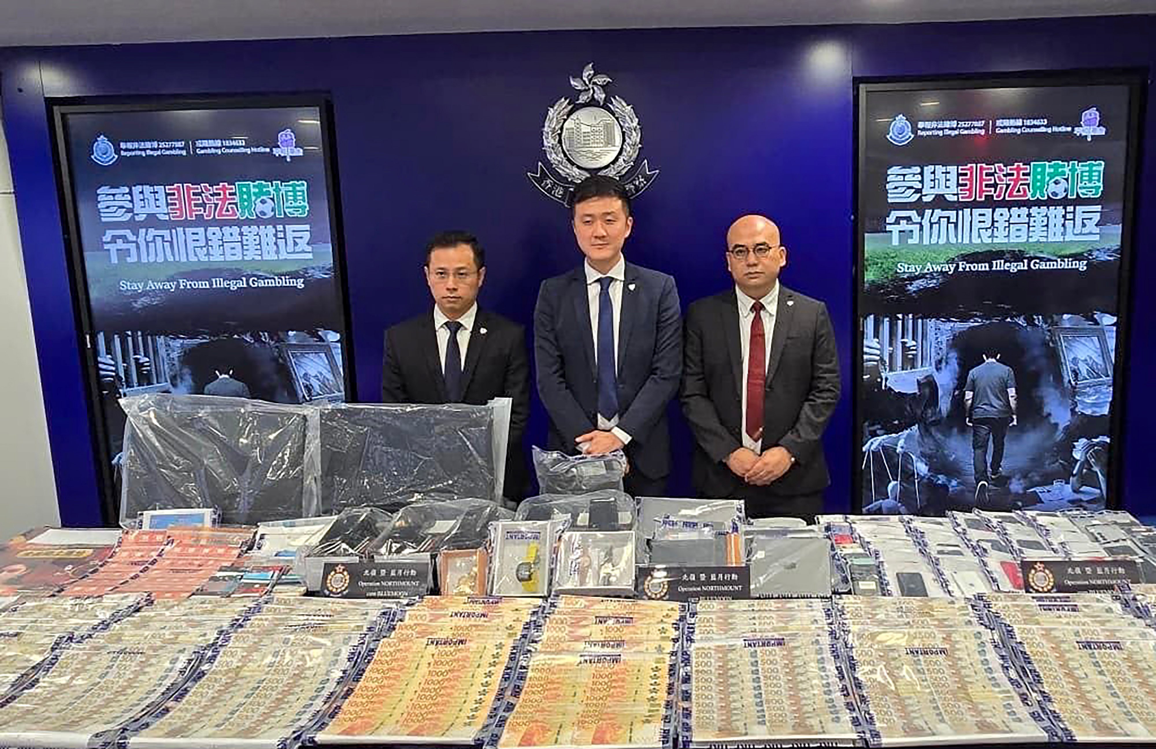Police officers seized HK$1 million in cash, HK$4 million in assets and large quantities of computers and mobile phones during the raids. Photo: Handout
