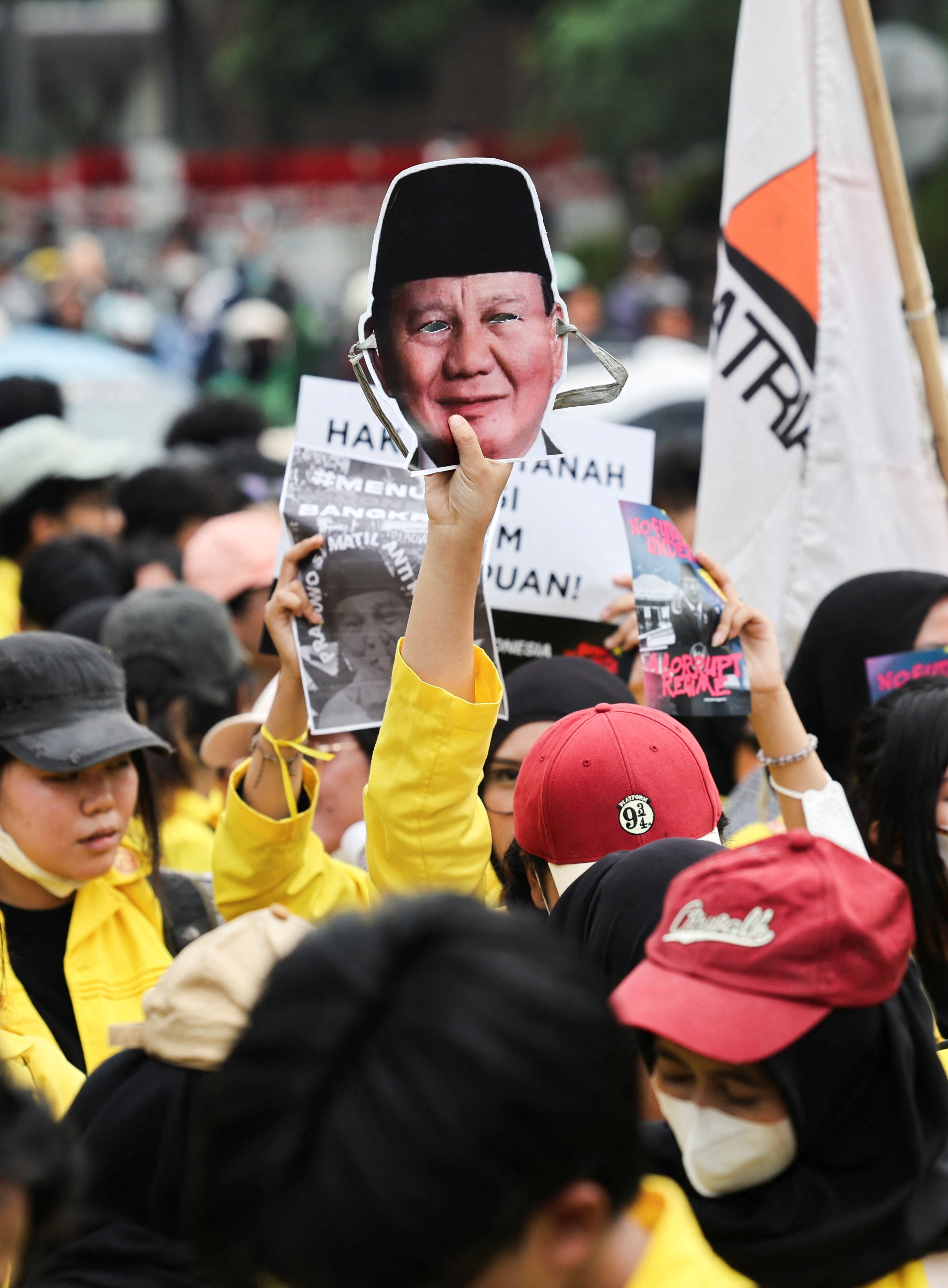 A student holds up a face mask depicting Indonesian President Prabowo Subianto during a protest against government policies, including state budget spending, fuel price hike, free meals programme, and expanded military roles in civilian affairs, in Jakarta, Indonesia, June 12, 2026. REUTERS/Ajeng Dinar Ulfiana