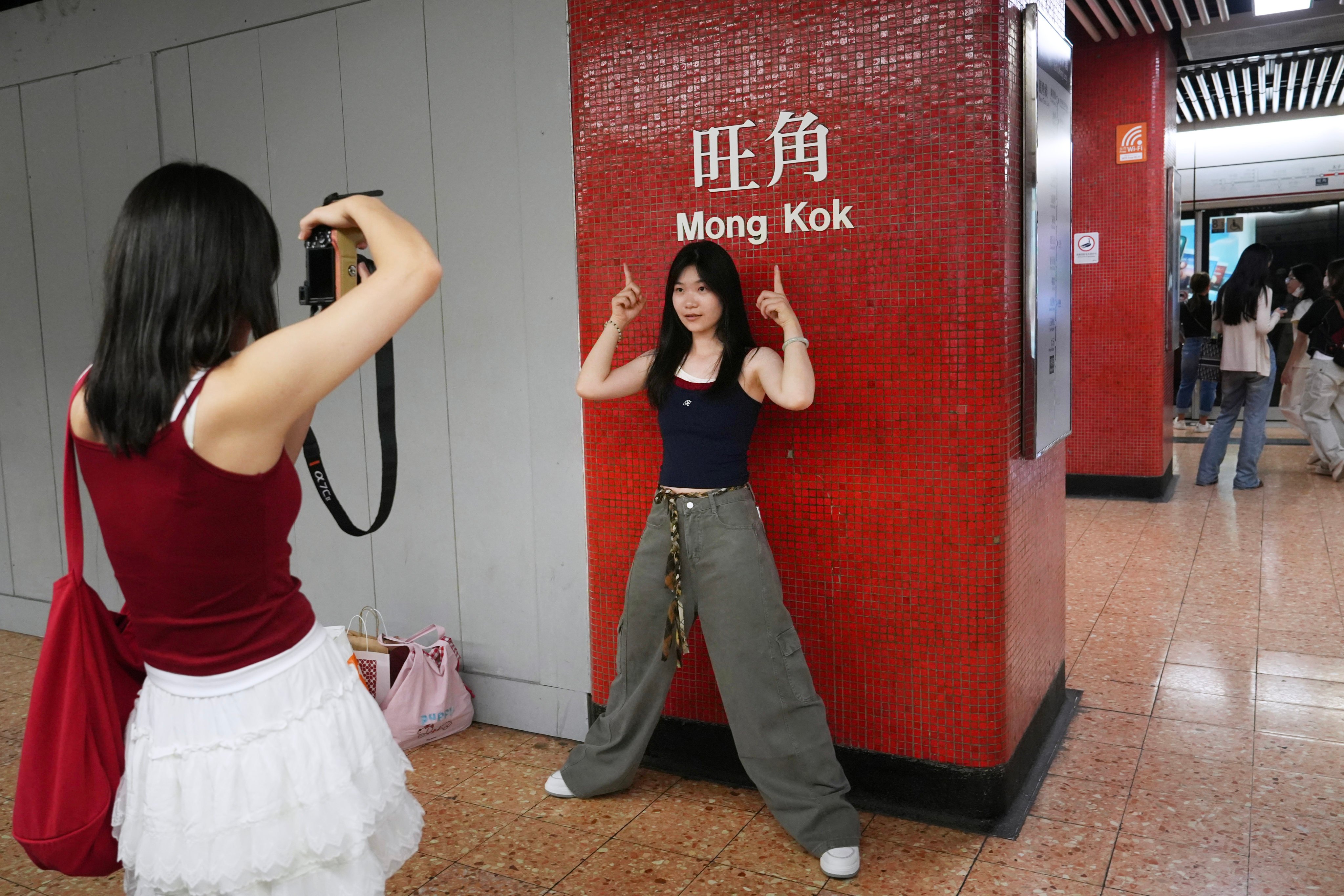 Tourists take photos at the Mong Kok MTR Station on October 6, 2025. Photo: Sun Yeung