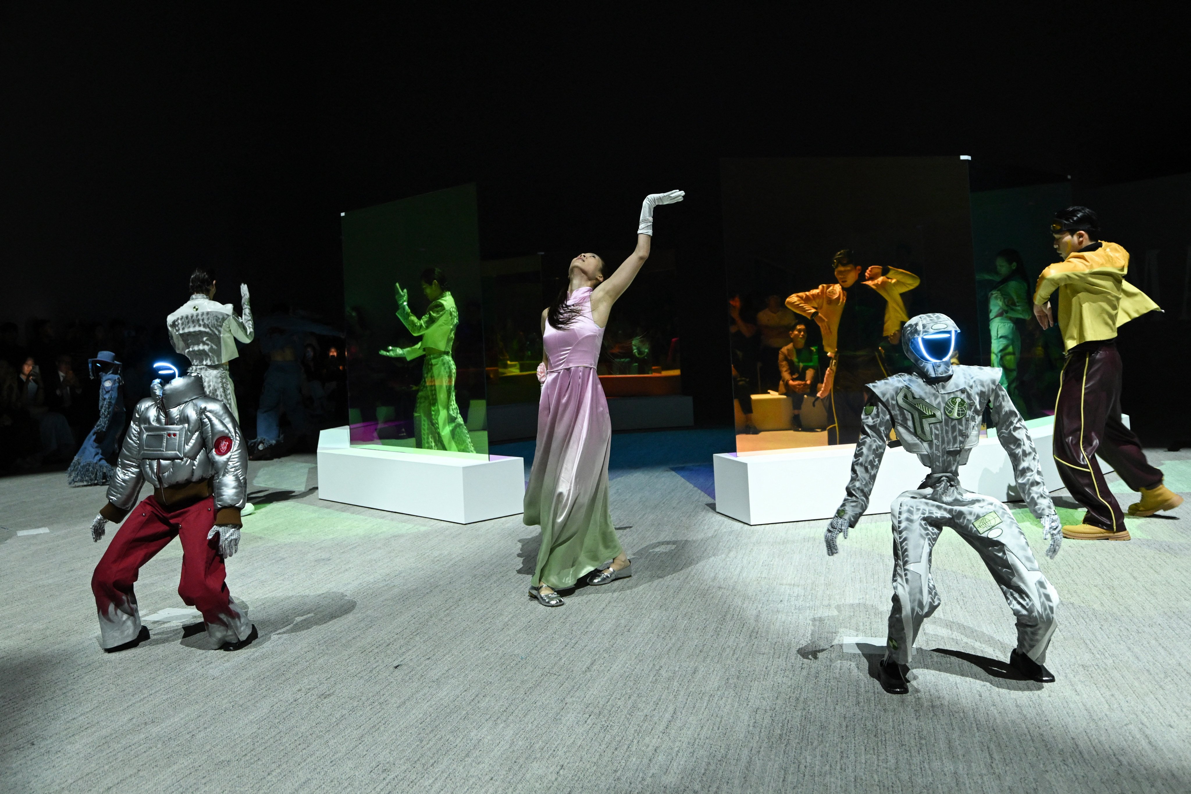 Humanoid robots and models perform as they present creations at Galaxy Corporation’s “Mach33: Physical AI Fashion Show” in Seoul on May 28, 2026. (Photo by Pedro PARDO / AFP)