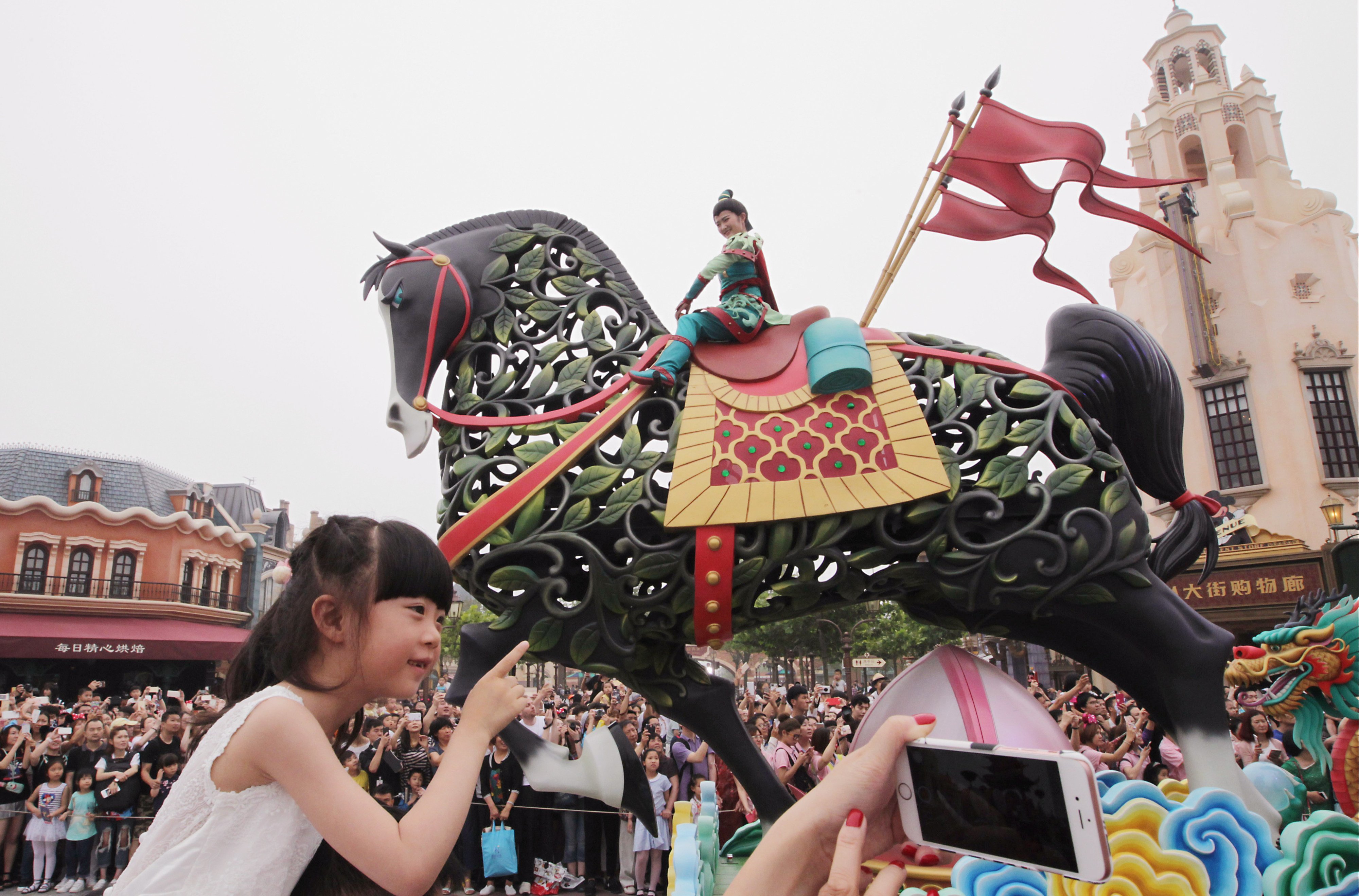 Tourists enjoy the parade at Shanghai’s Disneyland theme park on its opening day on June 16, 2016. Photo: Simon Song