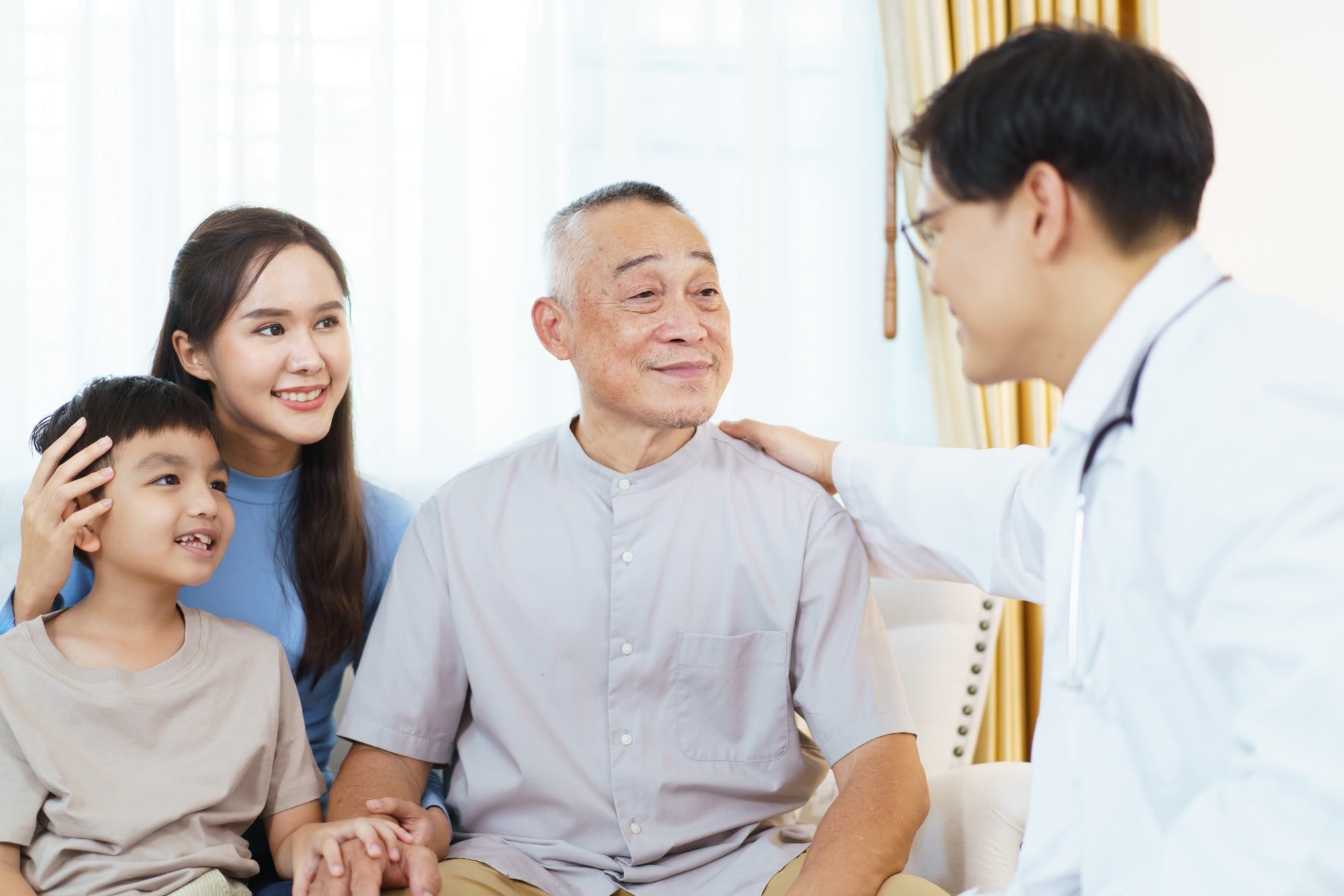A male doctor chats to an elderly man during a health check-up as he sits with two family members. Photo: Shutterstock A male doctor chats to an elderly man during a health check-up as he sits with two family members. Photo: Shutterstock