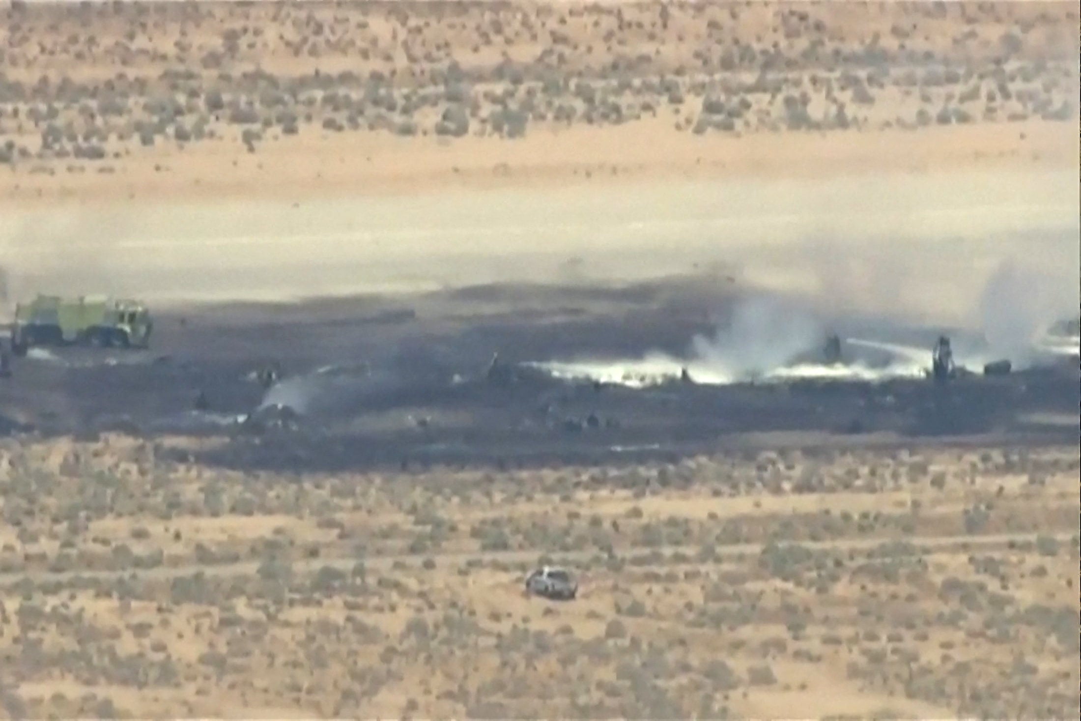 Smoke rises from a blackened part of Edwards Air Force Base after the crash of a B-52 bomber aircraft in Edwards, California, on Monday. Photo: ABC Affiliate KABC via Reuters