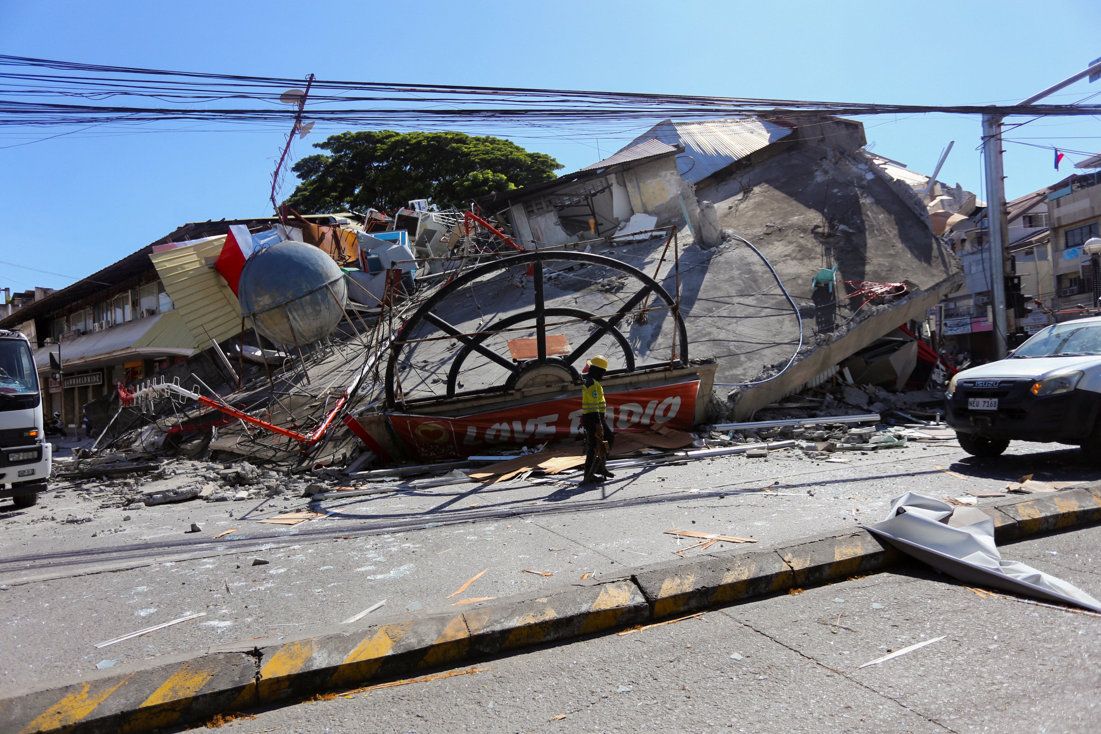 A worker walks near a collapsed building in General Santos, southern Philippines, on June 8 following the magnitude 7.8 quake. Photo: Reuters