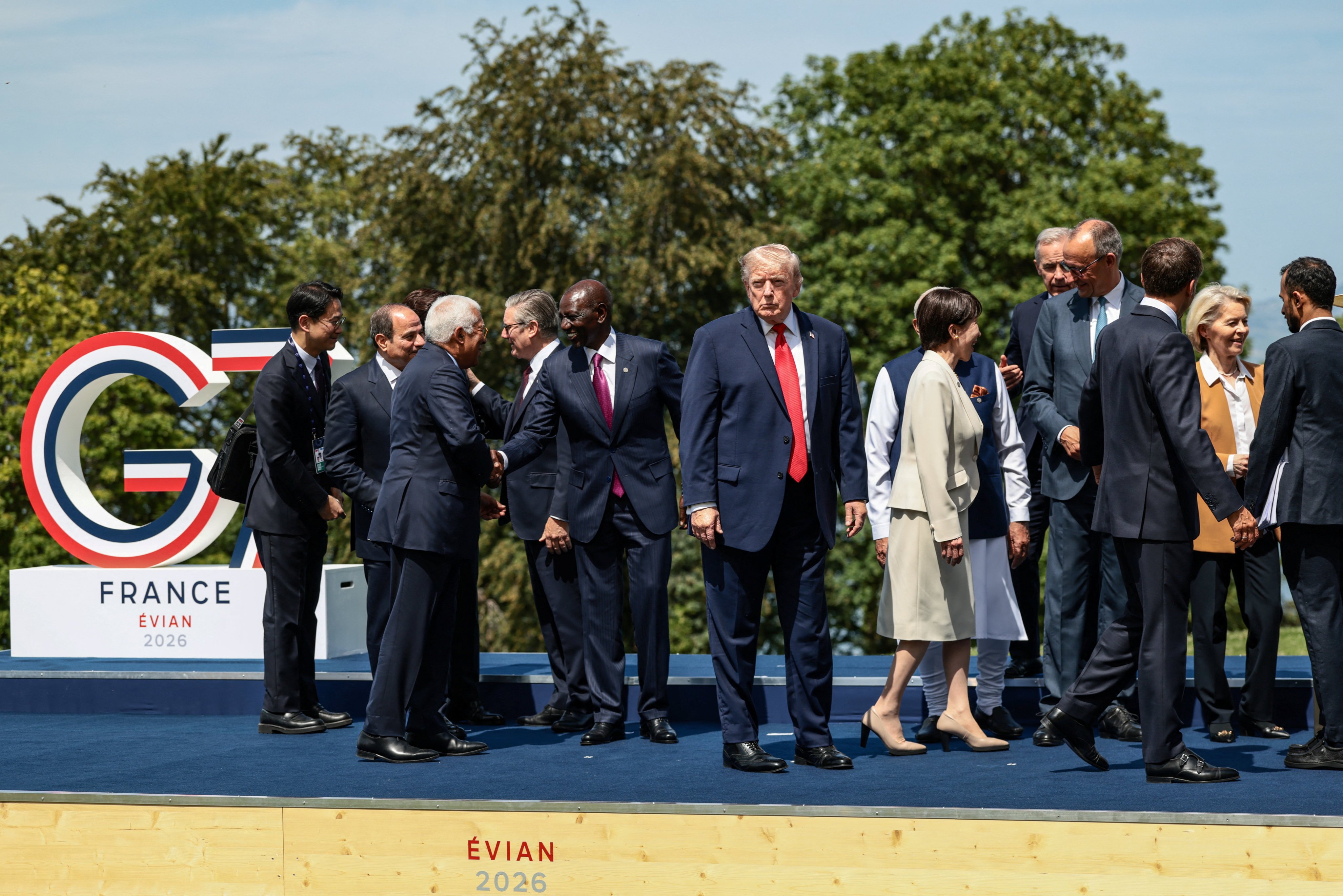 US President Donald Trump stands among fellow world leaders as they gather for a family photo at the G7 summit. Photo: Reuters