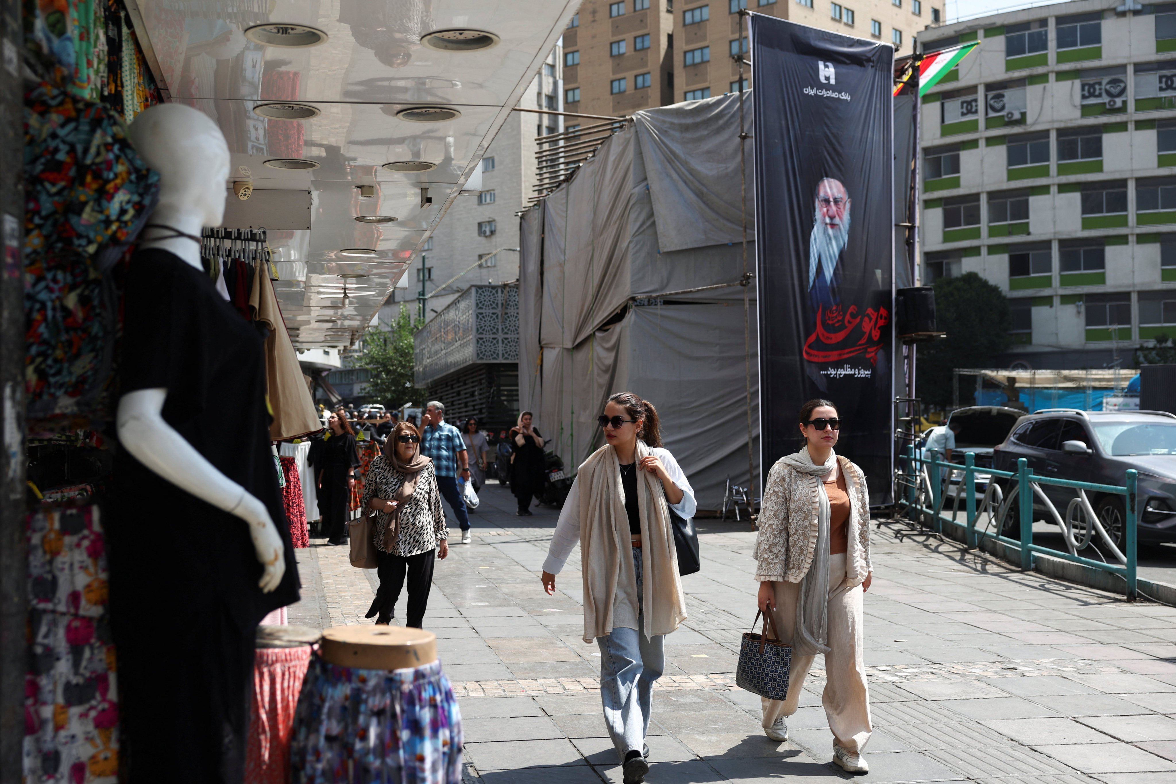 People walk past a banner with a picture of Iran’s late Supreme Leader Ayatollah Ali Khamenei in Tehran on Wednesday. Photo: WANA/Reuters