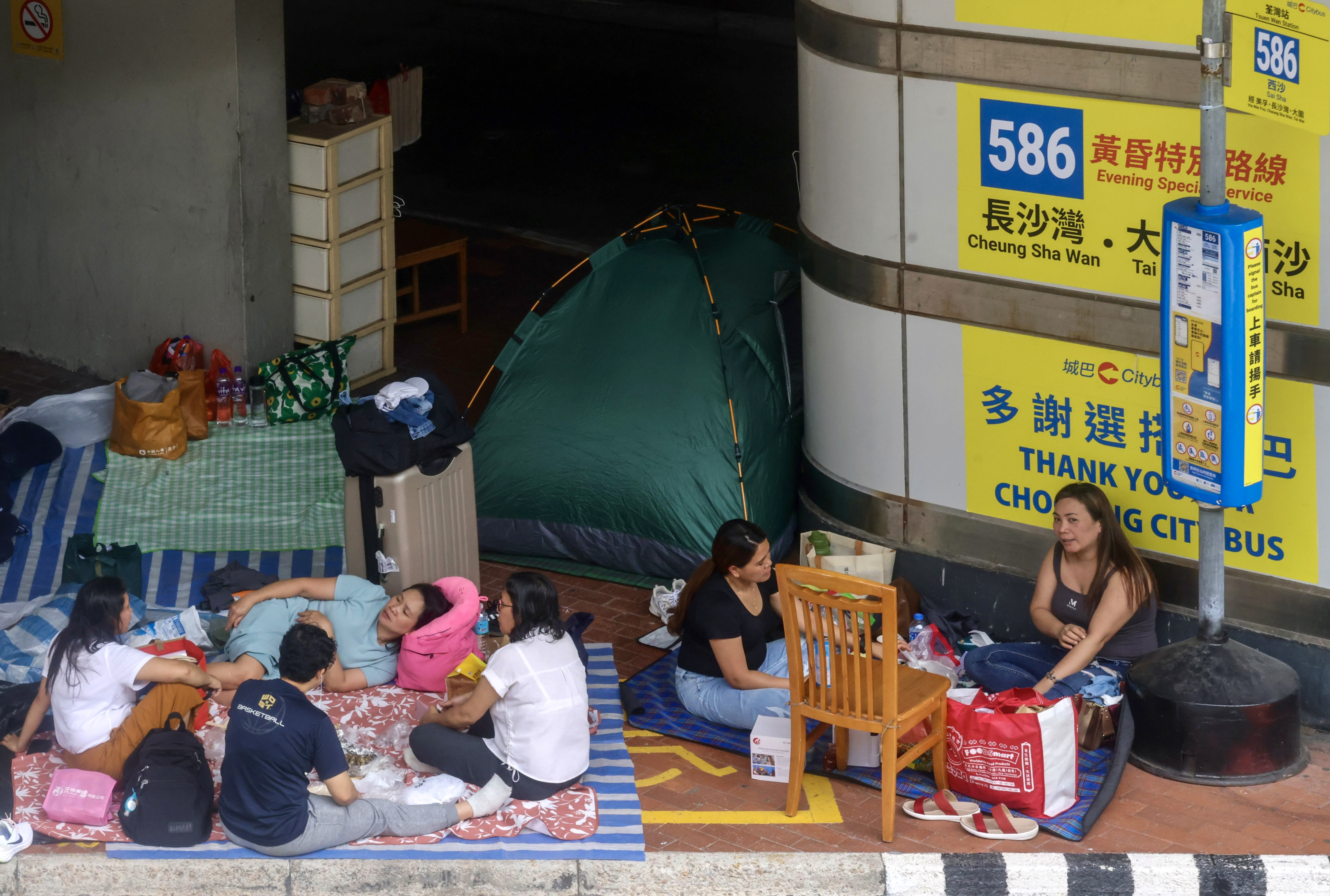 Hong Kong students debate mandatory comprehensive medical insurance for domestic workers. Proponents cite ethical care and health benefits, while opponents warn of unintended consequences. Photo: Jonathan Wong