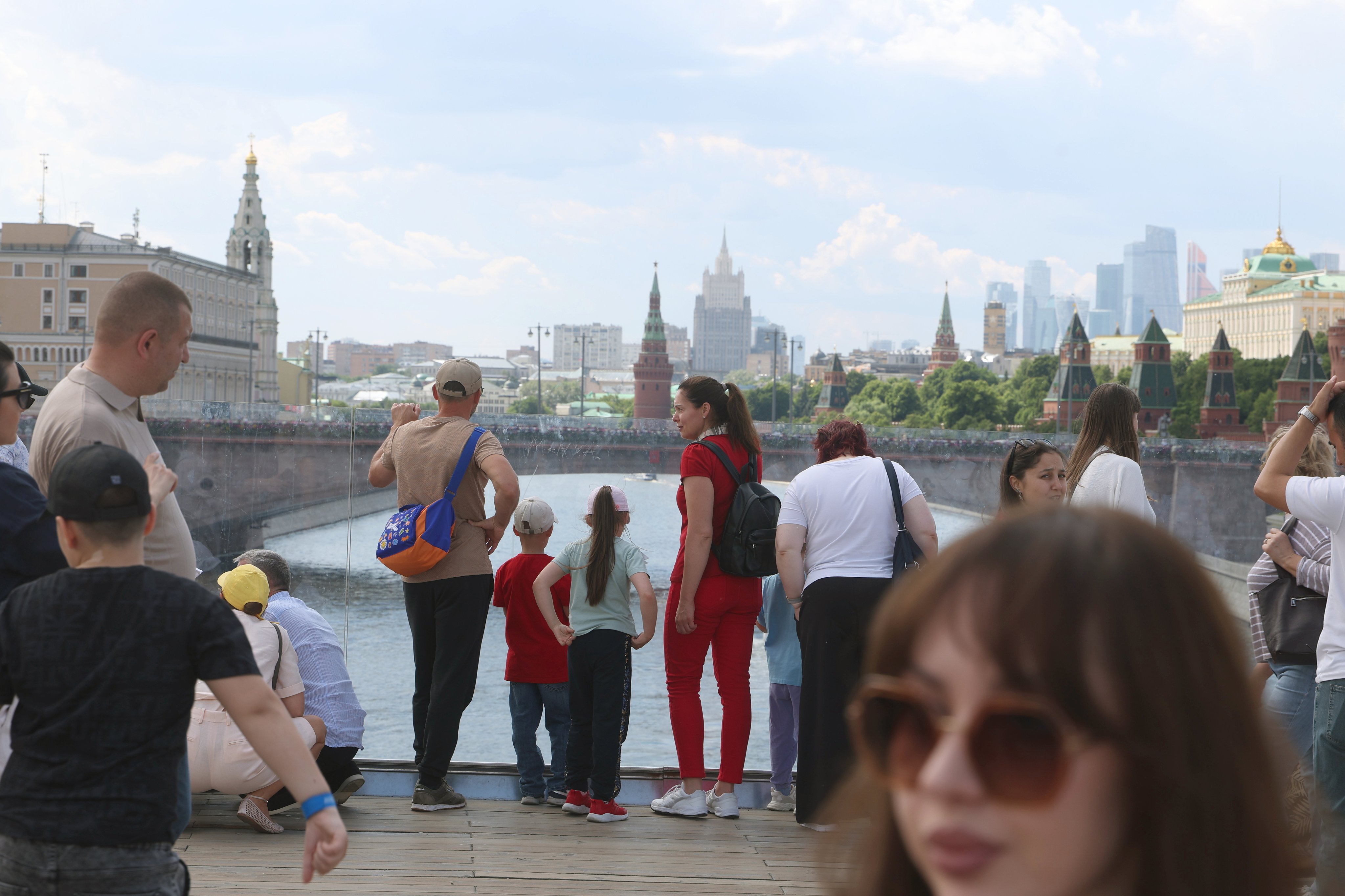 People take in the sights outside the Kremlin in downtown Moscow on June 5. Photo: EPA