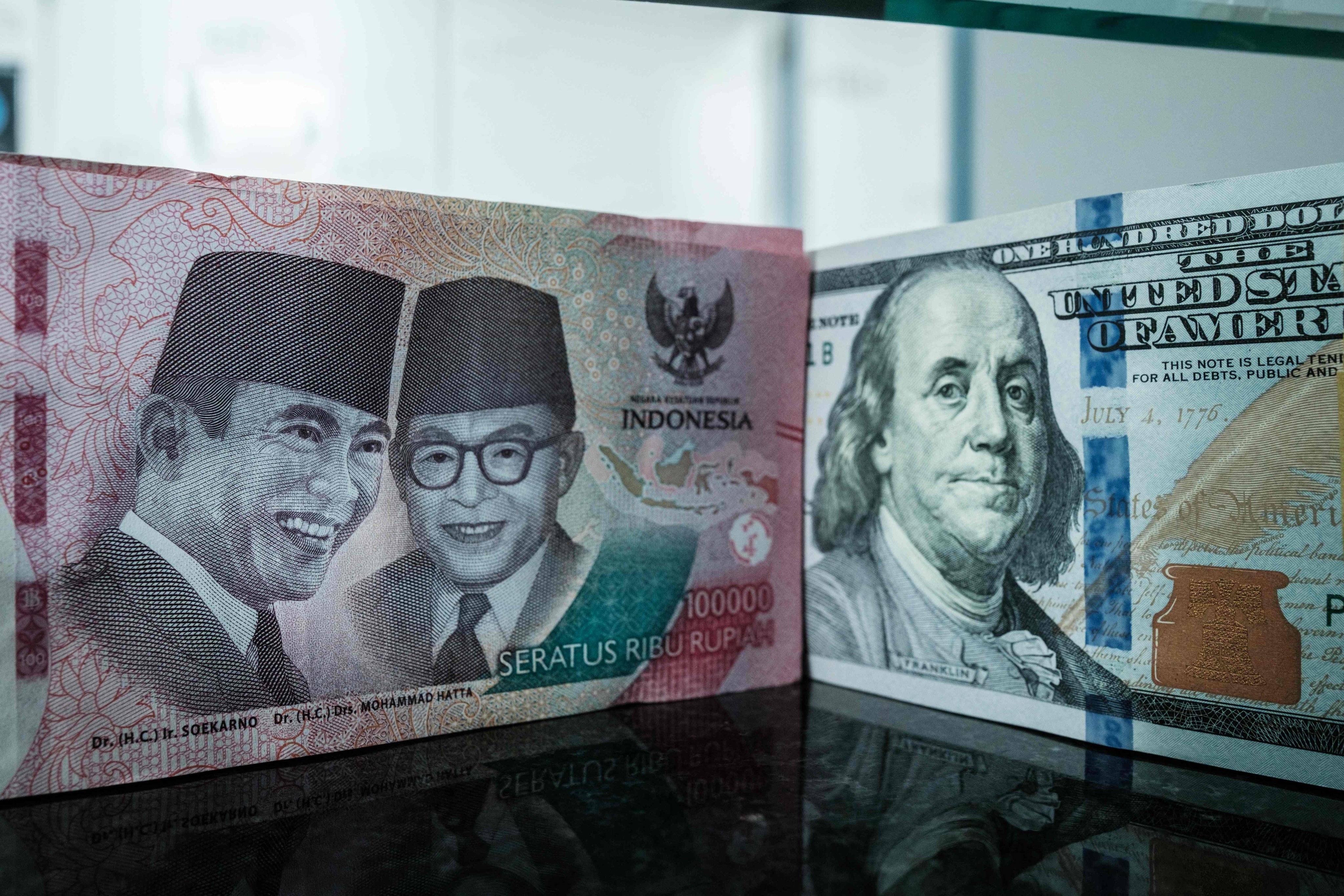 An Indonesian rupiah banknote pictured next to a US dollar banknote at a currency exchange office in Jakarta. Photo: AFP