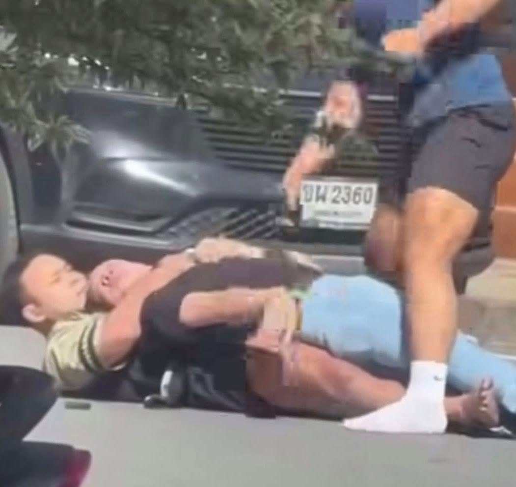 Two fitness instructors grab a suspect who allegedly shot his wife and her mother outside a gym near a market in Buriram province, Thailand, on Wednesday afternoon. Photo: Facebook/Siam Buriram Rescue