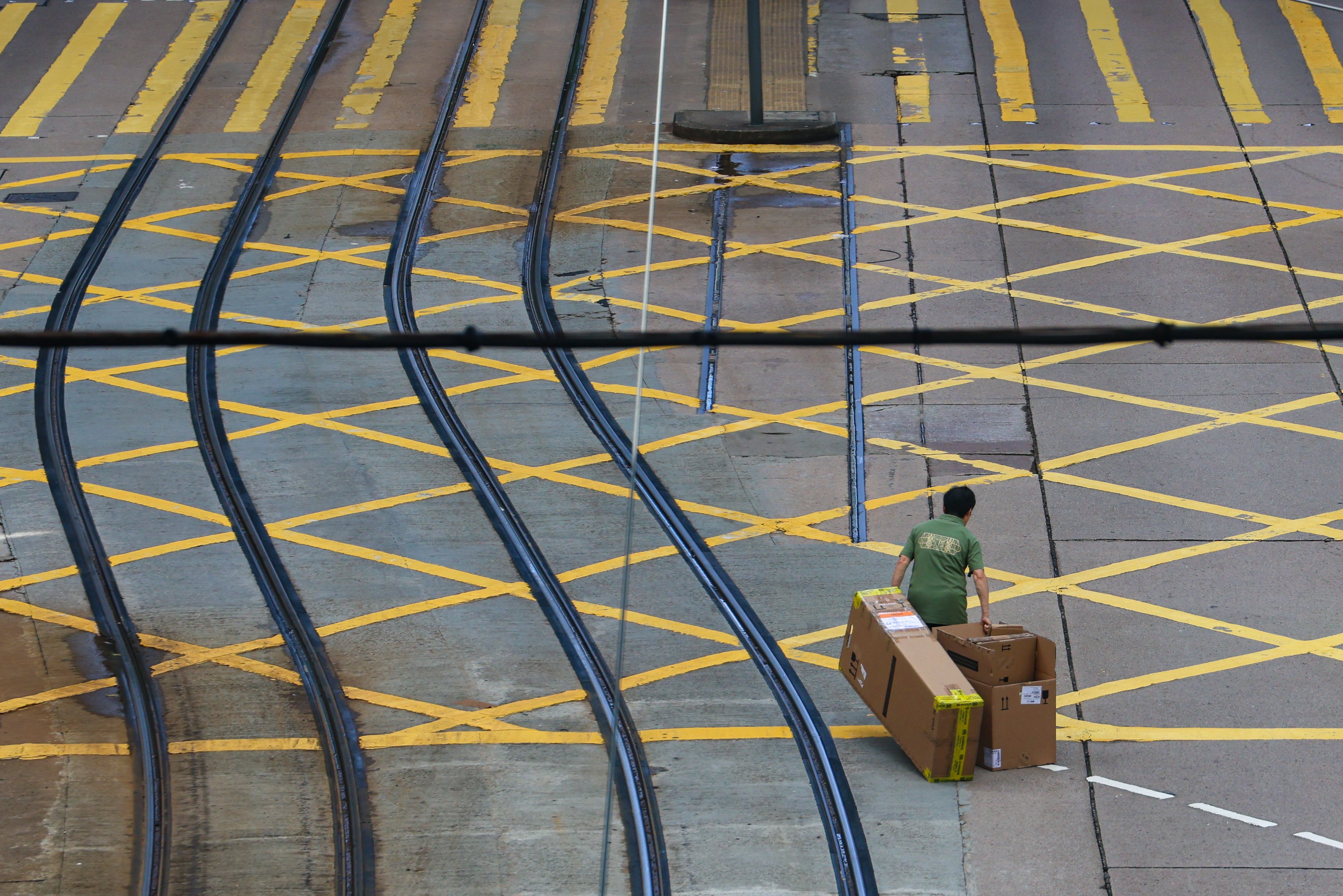A man drags cardboard boxes crosses a road in Central. Chief Secretary Eric Chan said the document was a report card of Hong Kong’s efforts to combat poverty. Photo: Jelly Tse