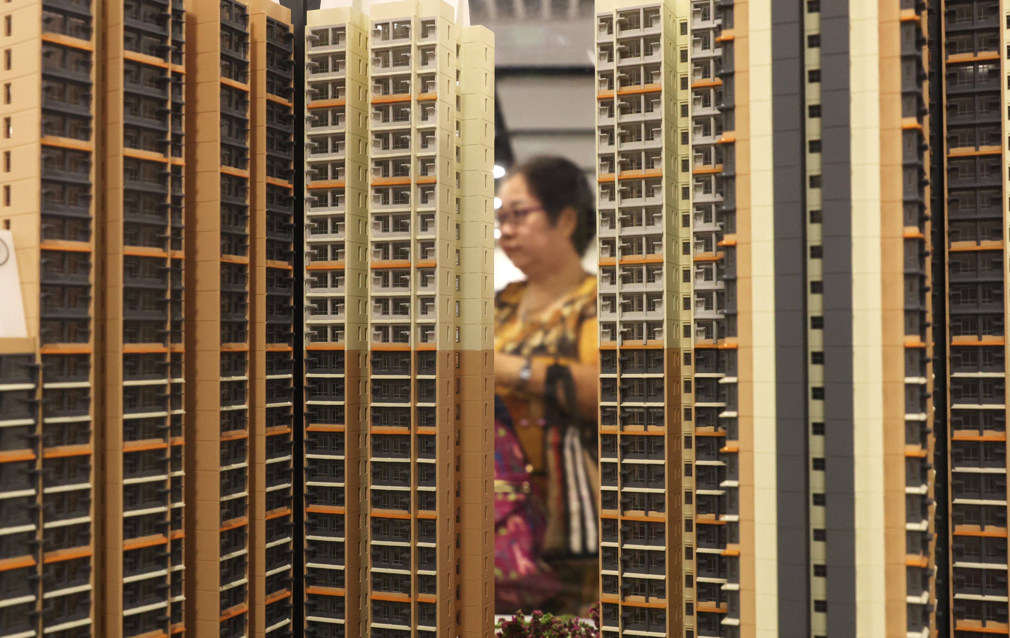 A potential home buyer looks at a scale model of a subsidised housing estate. Photo: Yik Yeung-man