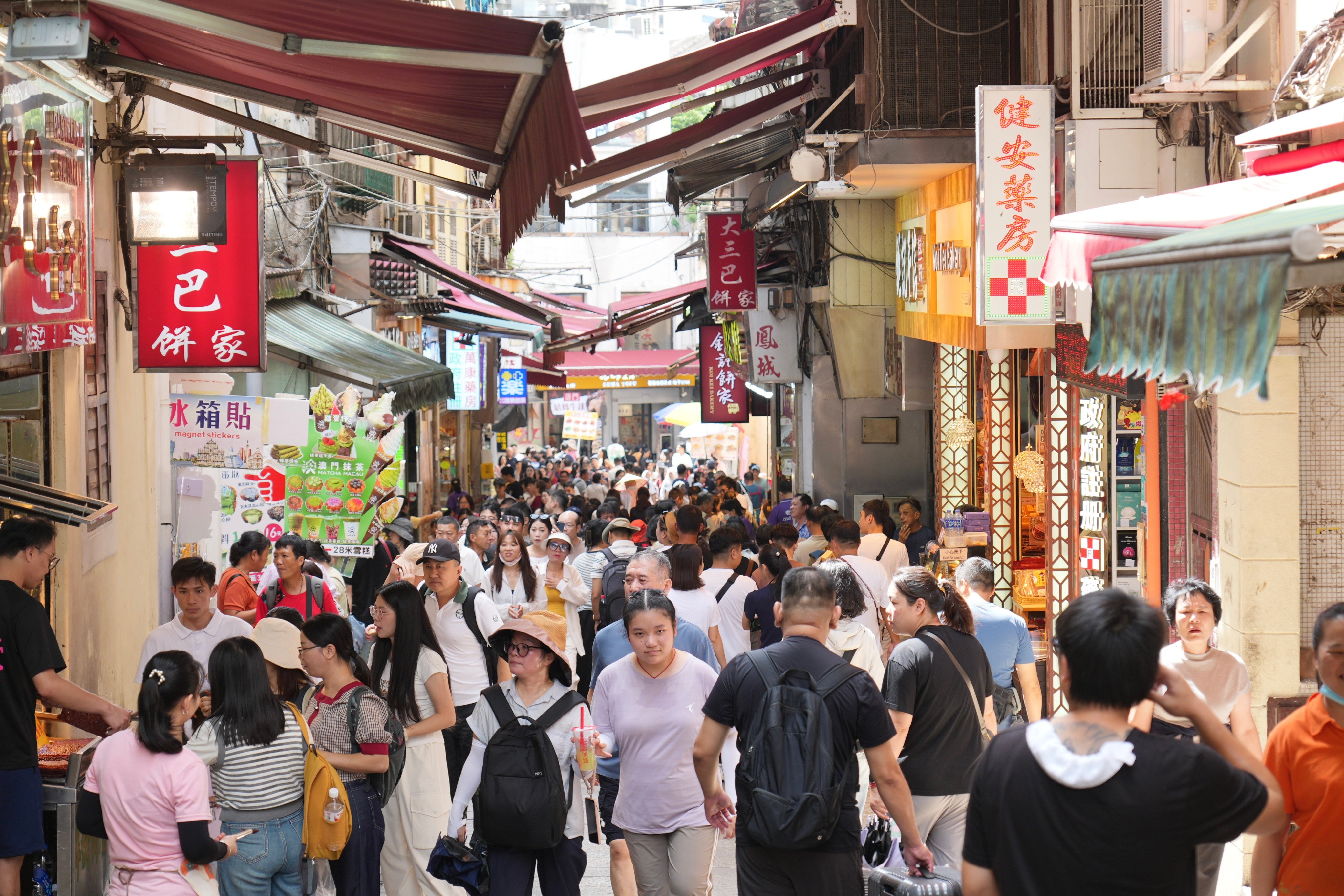 Tourists pack the narrow streets of Macau. Photo: Karma Lo