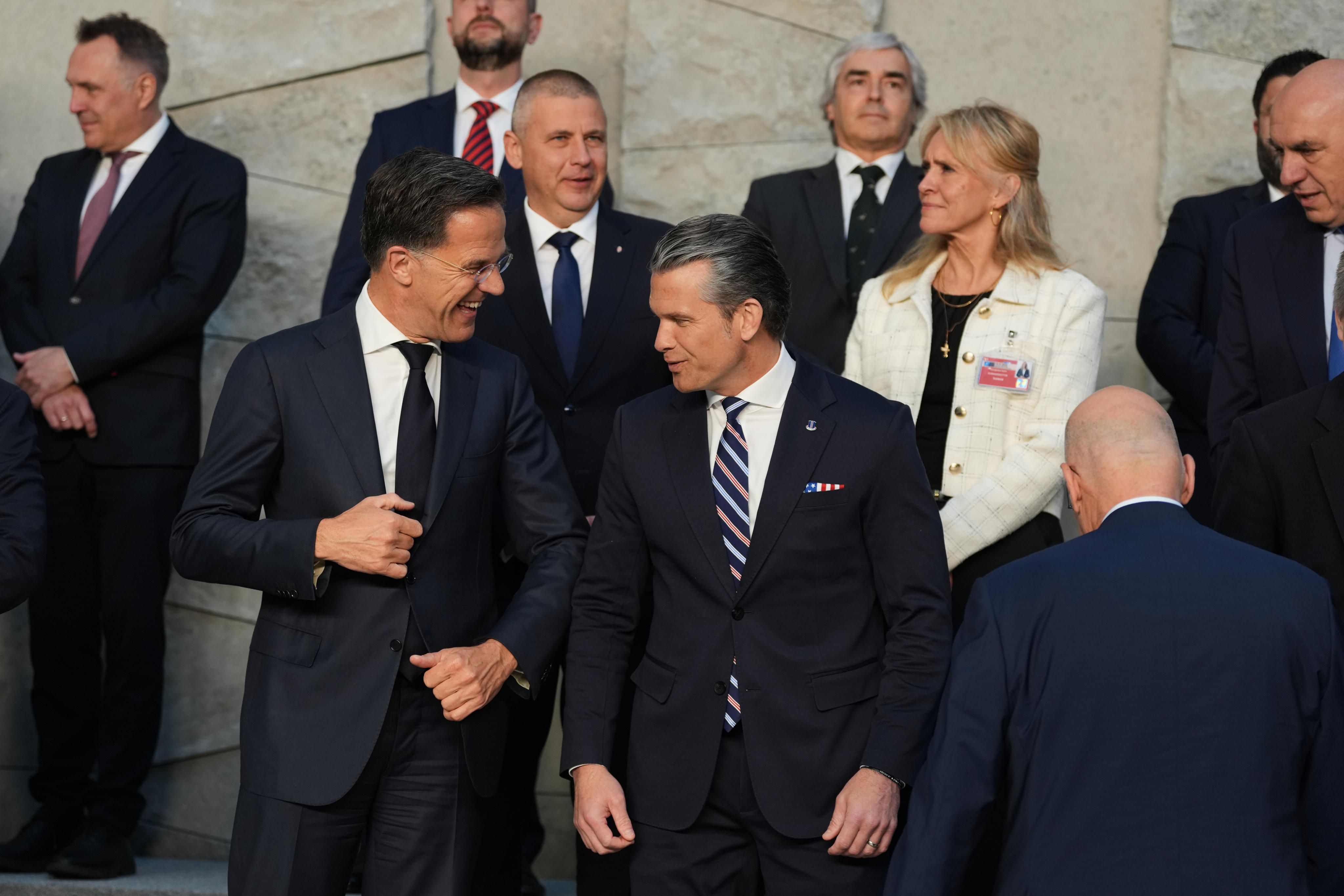 Nato Secretary General Mark Rutte (left) banters with US Defence Secretary Pete Hegseth during a group photo taking at Nato headquarters in Brussels on Thursday. Photo: AP