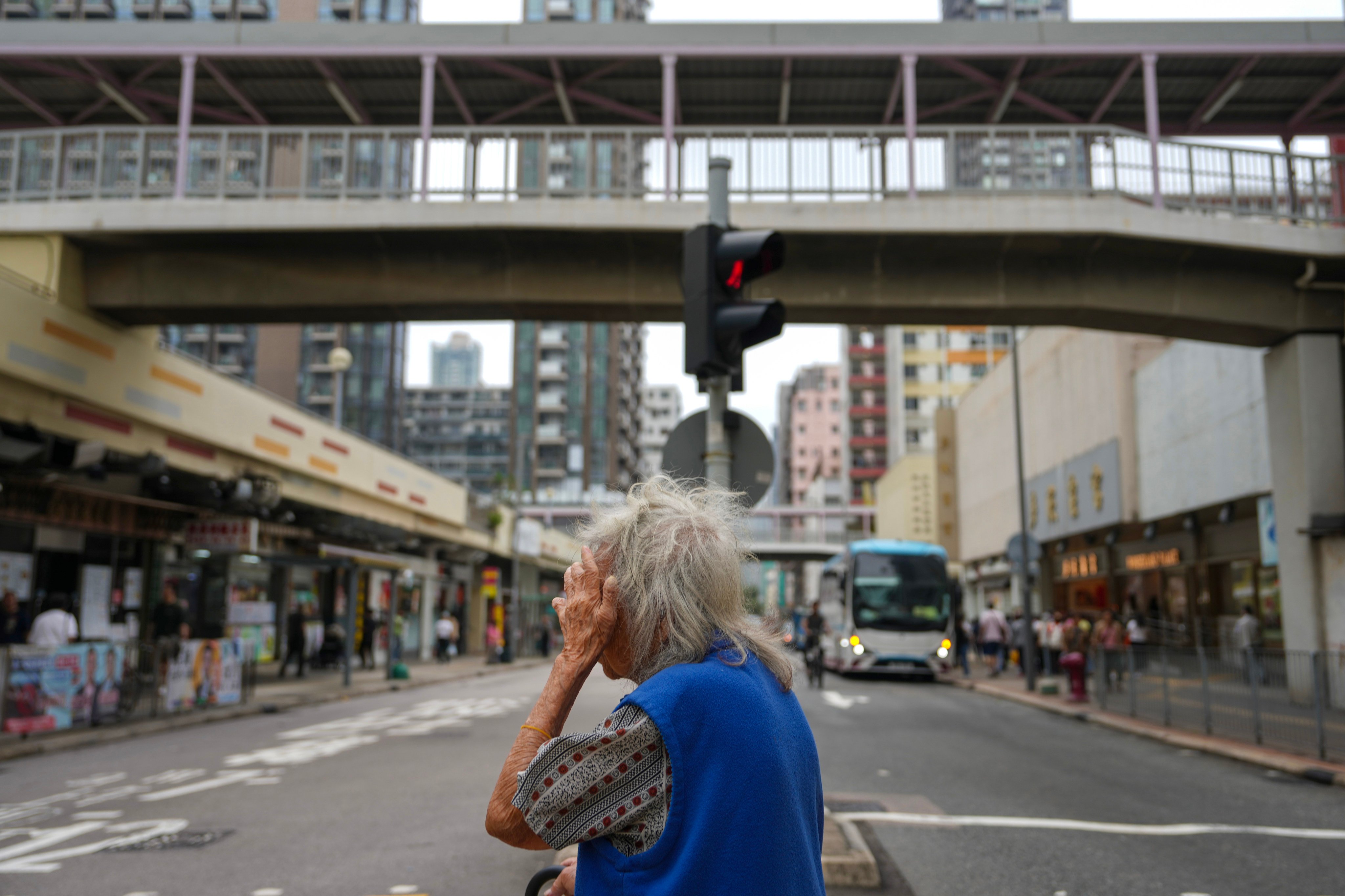An elderly woman crosses a street in Shek Kip Mei. There are 491,200 all-elderly households in Hong Kong, according to a government report. Photo: Sam Tsang