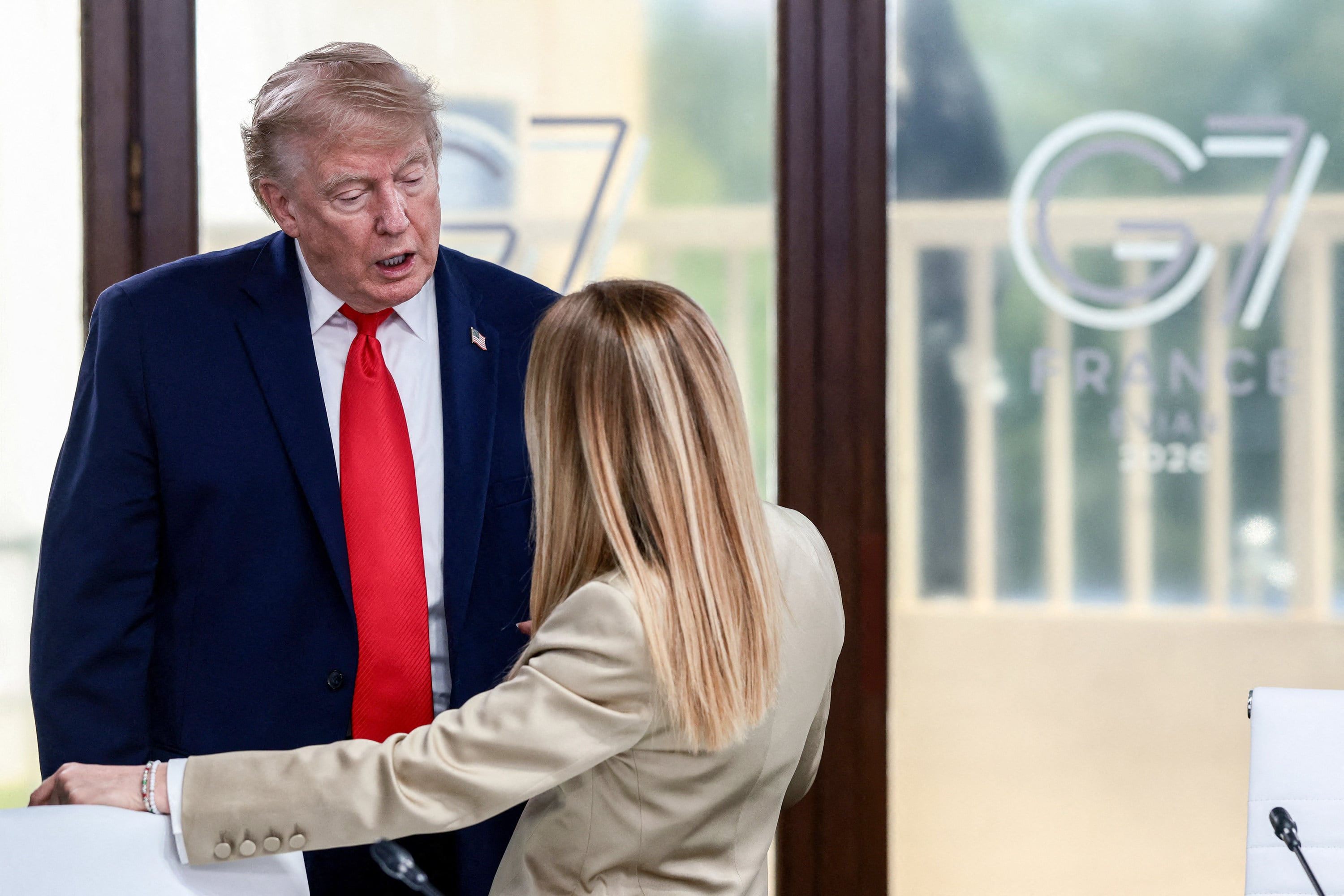 US President Donald Trump speaks with Italy’s Prime Minister Giorgia Meloni at the G7 summit in Evian, eastern France, on Tuesday. Photo: TNS