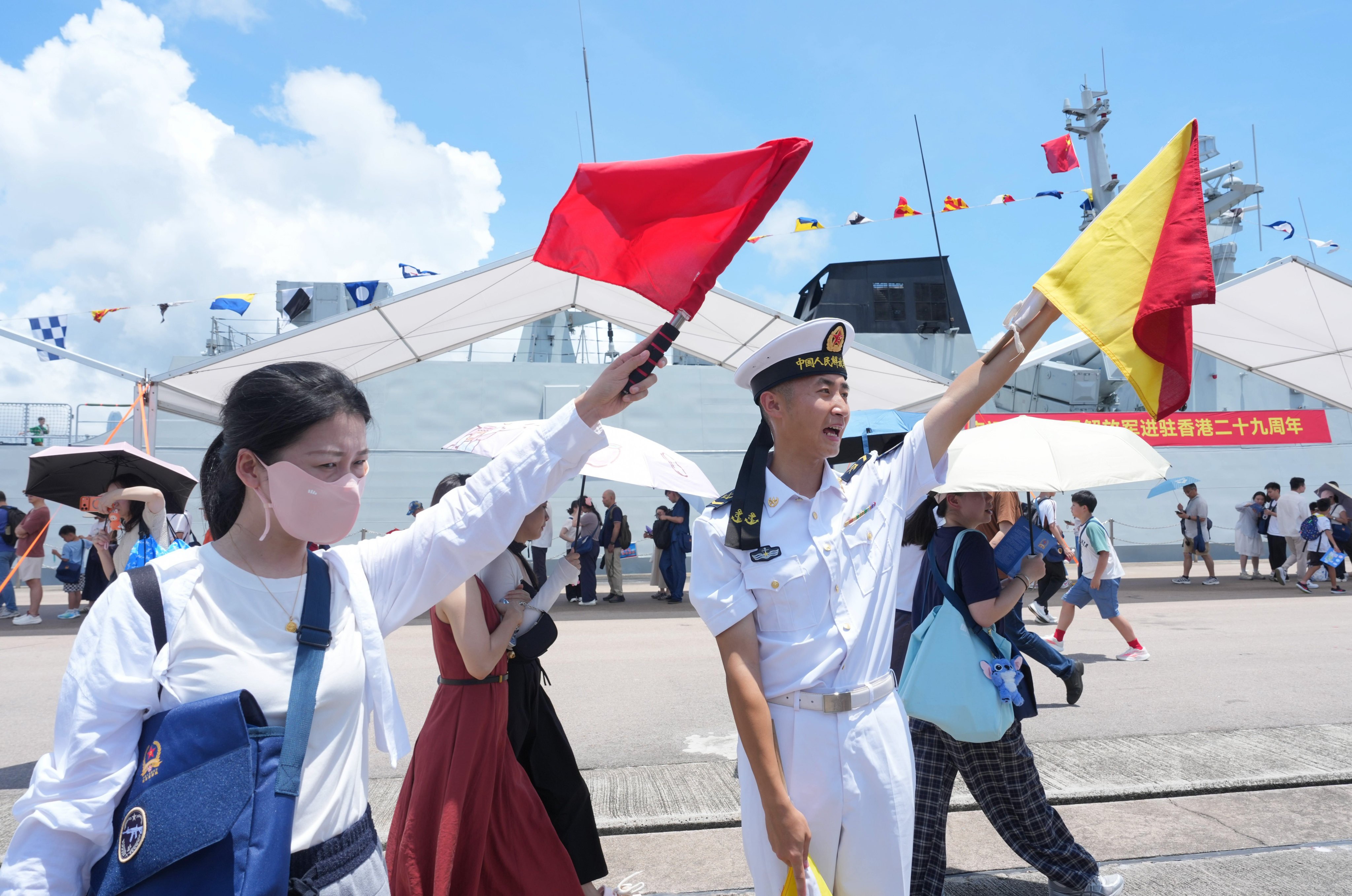 Visitors wave flags at the Ngong Shuen Chau Barracks. Photo: Dickson Lee