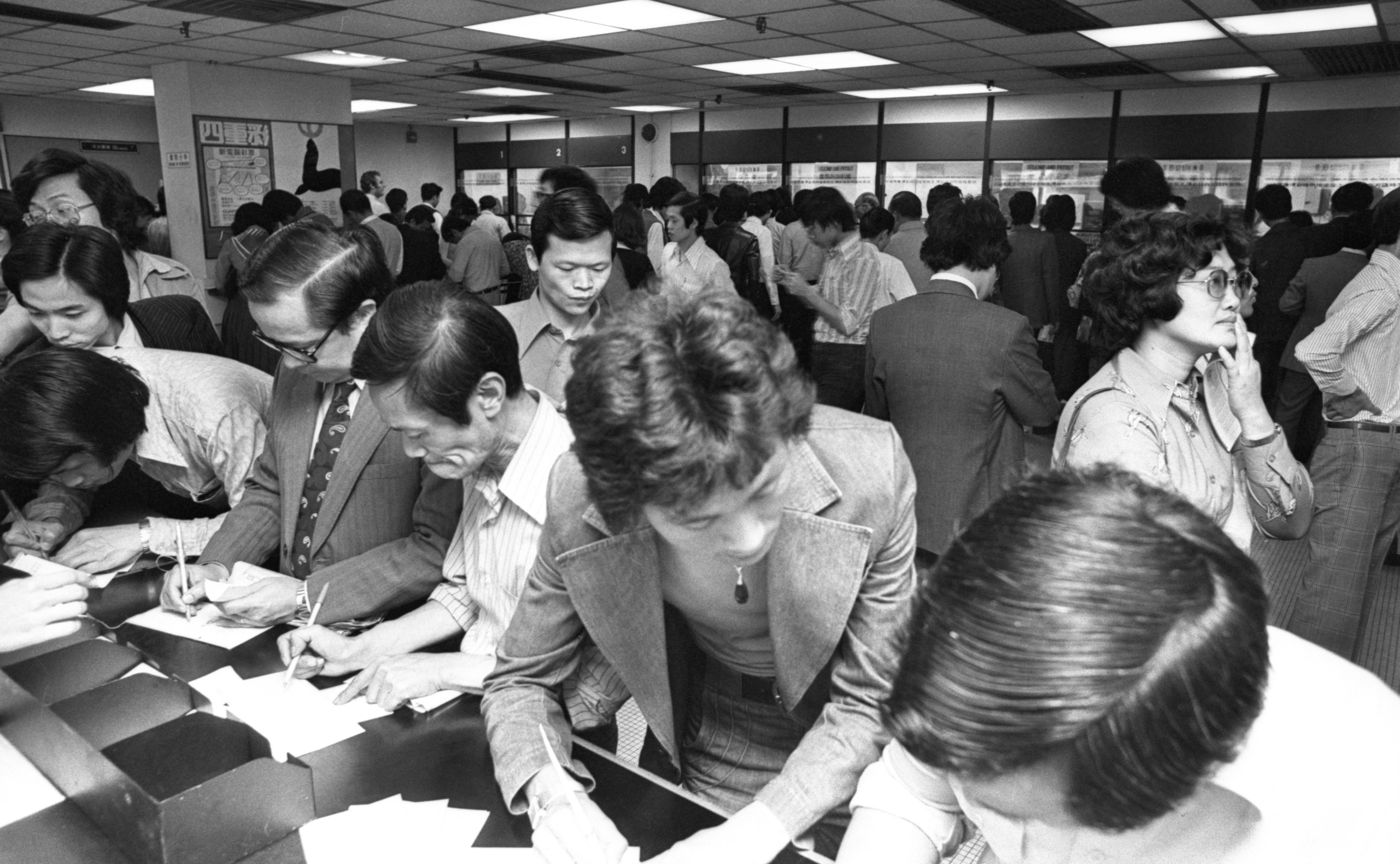 People fill in Mark Six lottery tickets in a betting shop in 1977. Photo: SCMP Archives