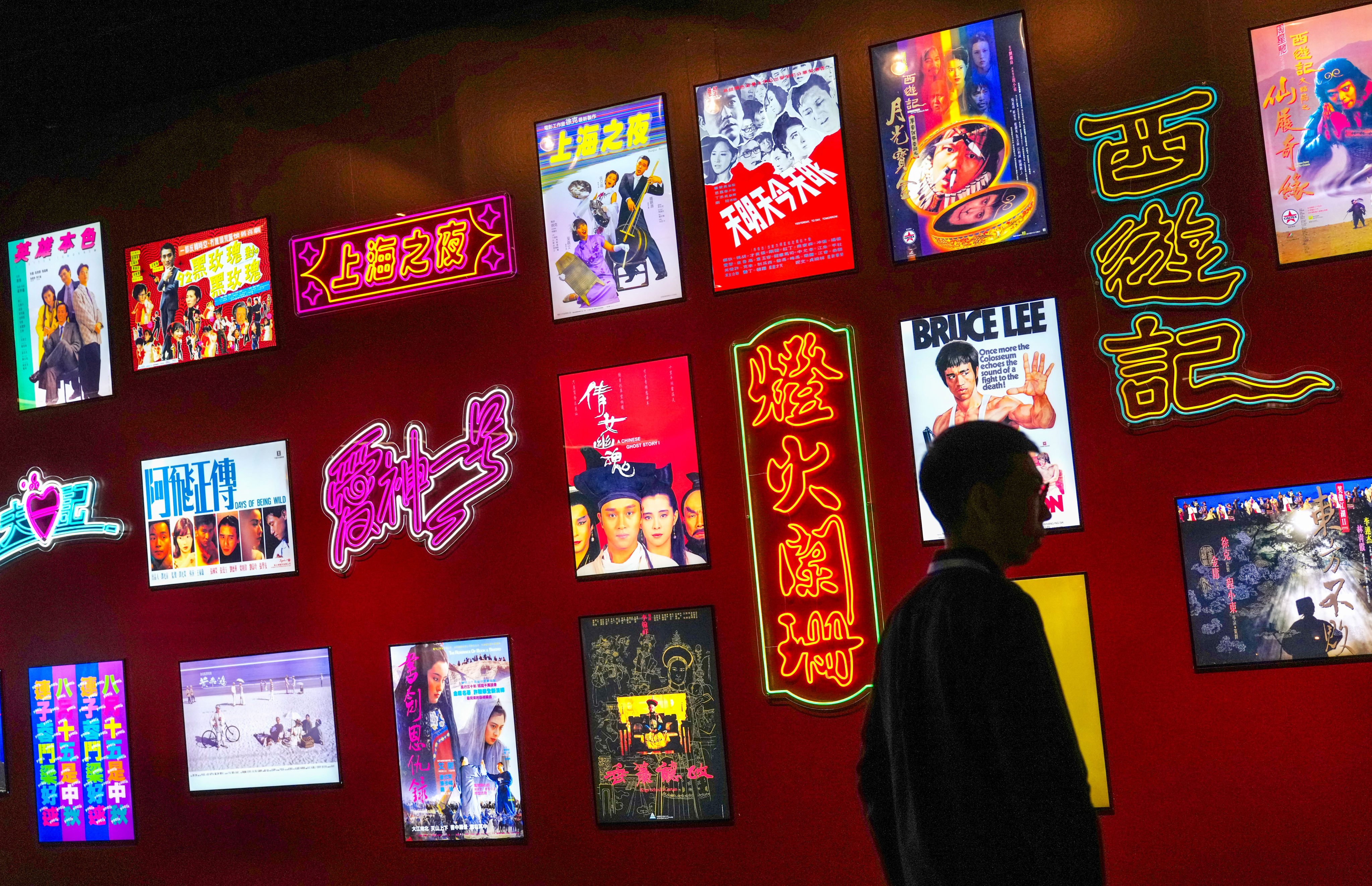 A neon-lit poster wall celebrates classic Hong Kong cinema at the “Hong Kong Film Archive Stories: Treasure Hunting for 25 Years” exhibition. Photo: Karma Lo