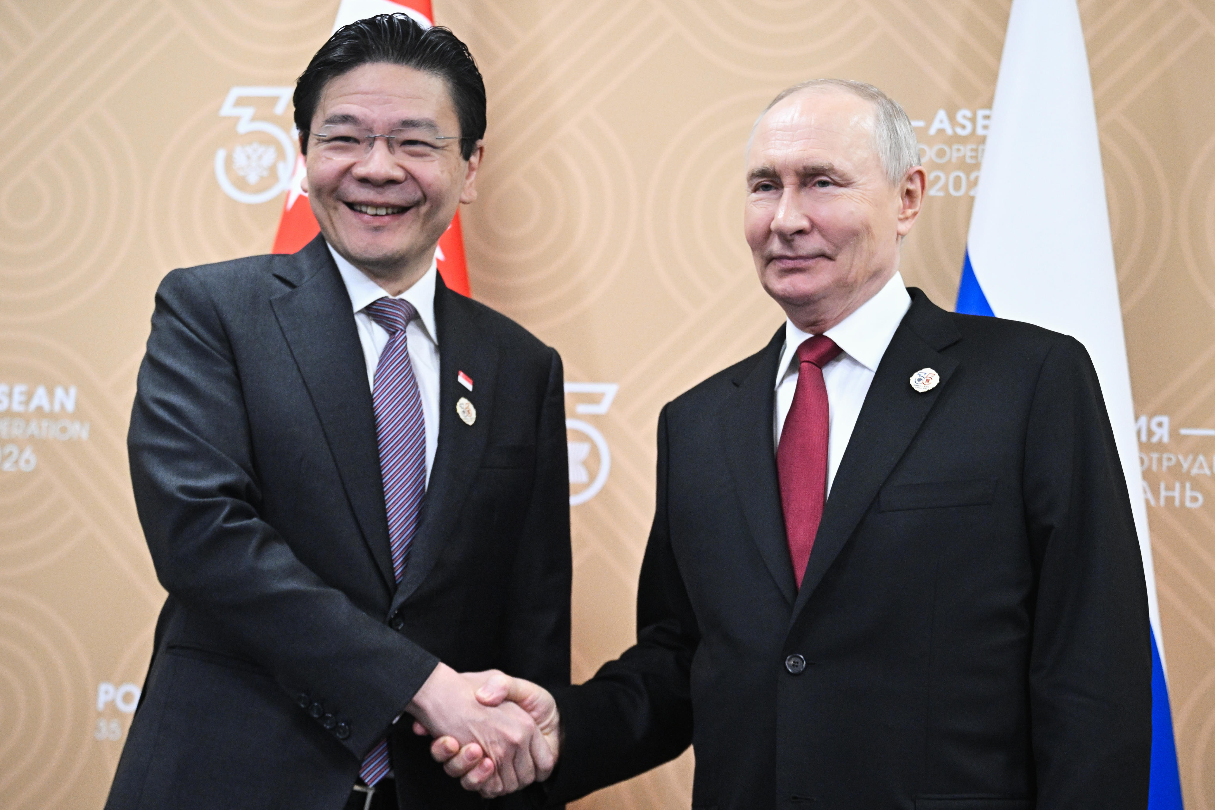 Singaporean Prime Minister Lawrence Wong (left) and Russian President Vladimir Putin shake hands during their meeting on the sidelines of the Russia-Asean Summit in Kazan on Thursday. Photo: 
Sputnik/AP
