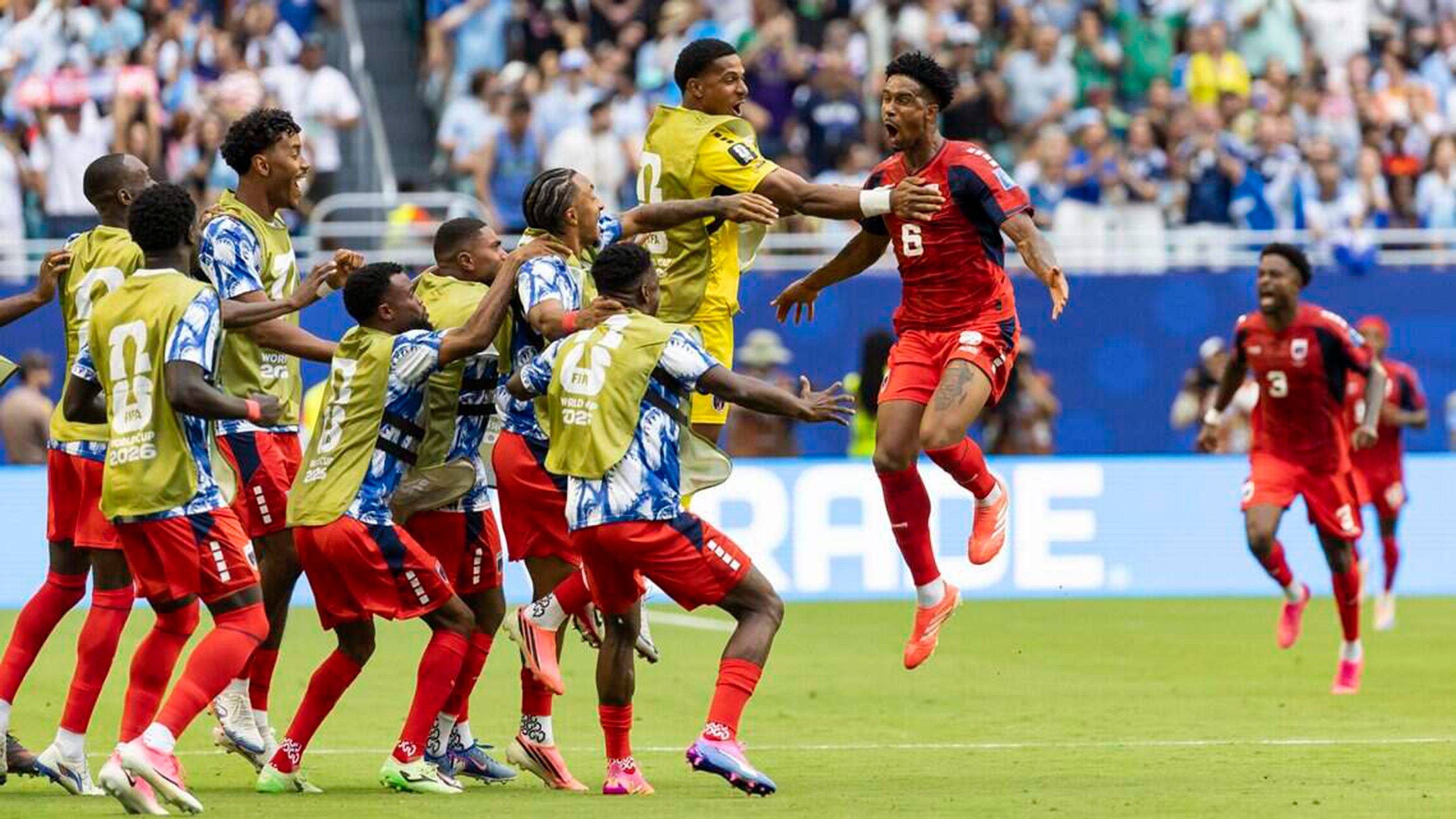 Cabo Verde’s Kevin Pina shares the joy of scoring his country's first World Cup finals goal with team reserves in their match against Uruguay at Hard Rock Stadium in Miami on Sunday. Photo: dpa