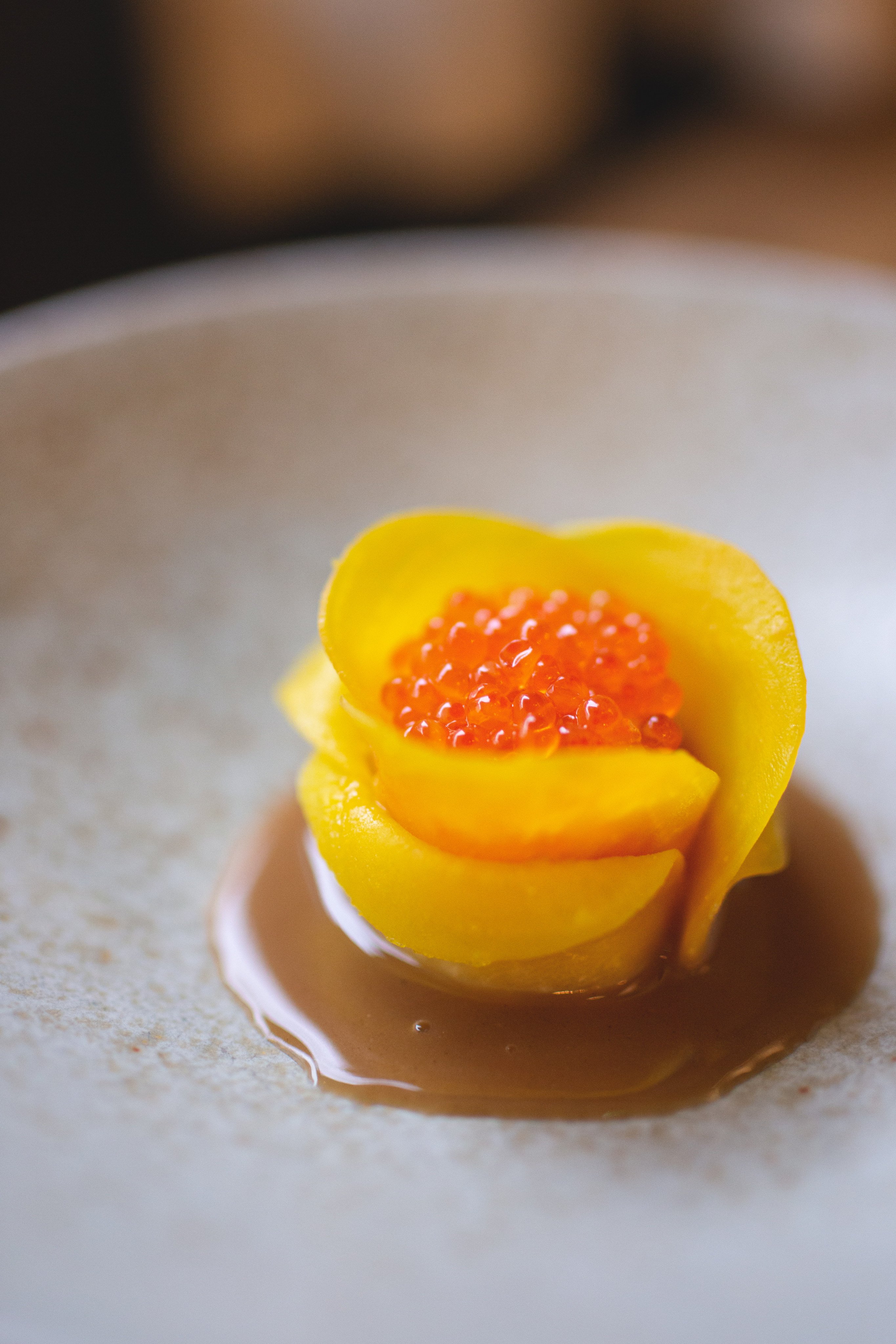 Ng’s take on siu mai is wrapped in golden beetroot slices, topped with trout roe and served with a chicken jus infused with Shaoxing wine. Photo: Calambour