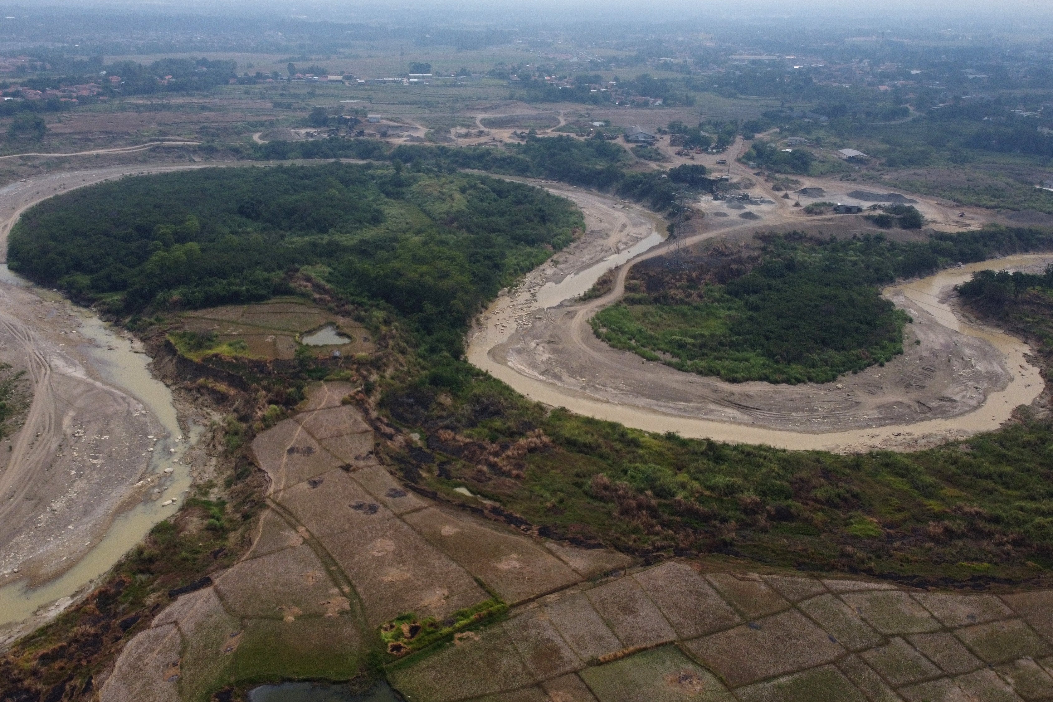 An aerial view of barren farmland on the banks of the Cipamingkis River in Indonesia's West Java province. Photo: NurPhoto via Getty Images