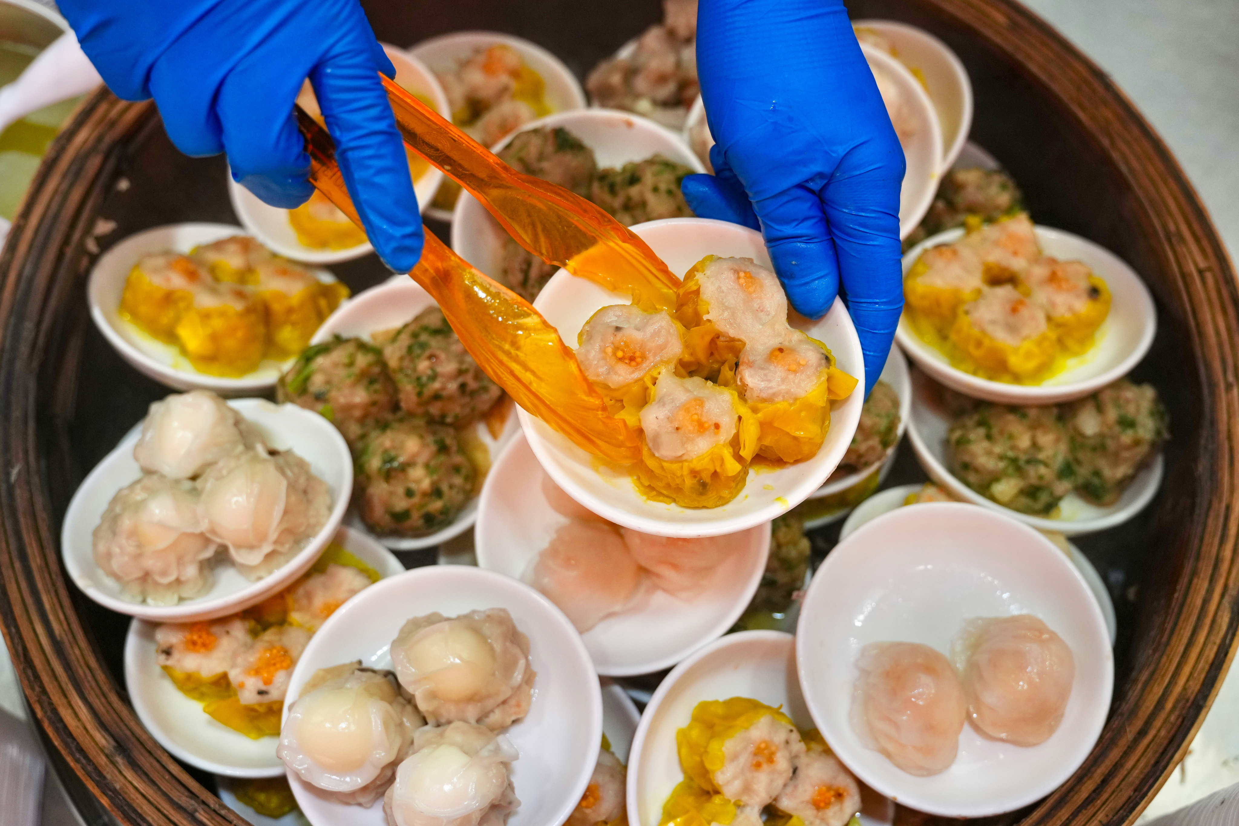 A bamboo basket filled with freshly steamed dim sum dishes. Photo: Karma Lo