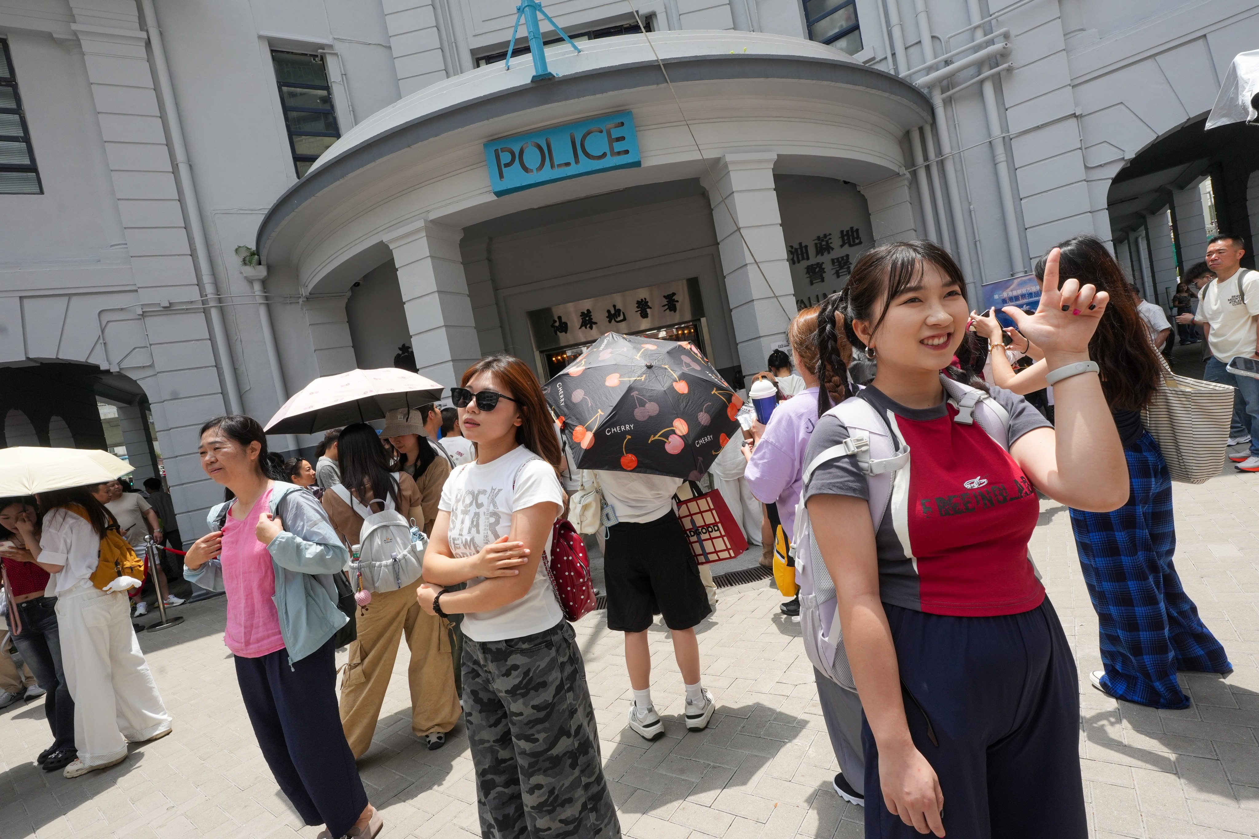 Tourists take photos outside the former Yau Ma Tei police station. Photo: Sun Yeung