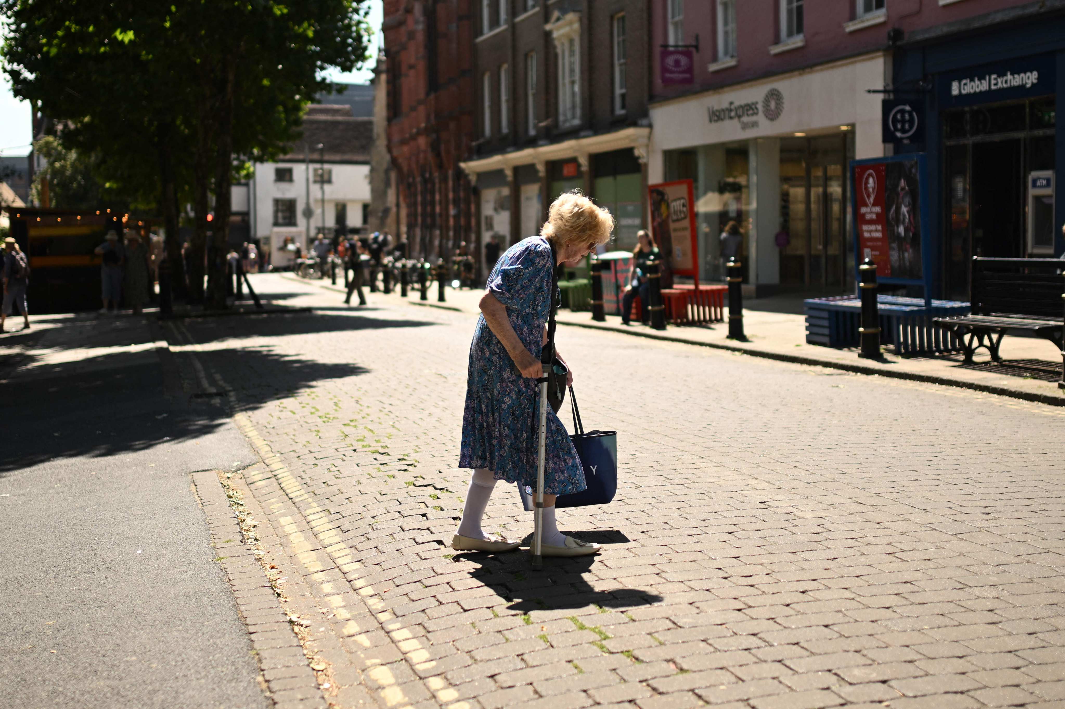 A woman walks past shops during a heatwave in England’s northern city of York on Wednesday. Britain’s meteorological office has issued a very rare red heat warning -  only issued once before - for Wednesday and Thursday, as temperatures could soar to 40 degrees. Photo: AFP