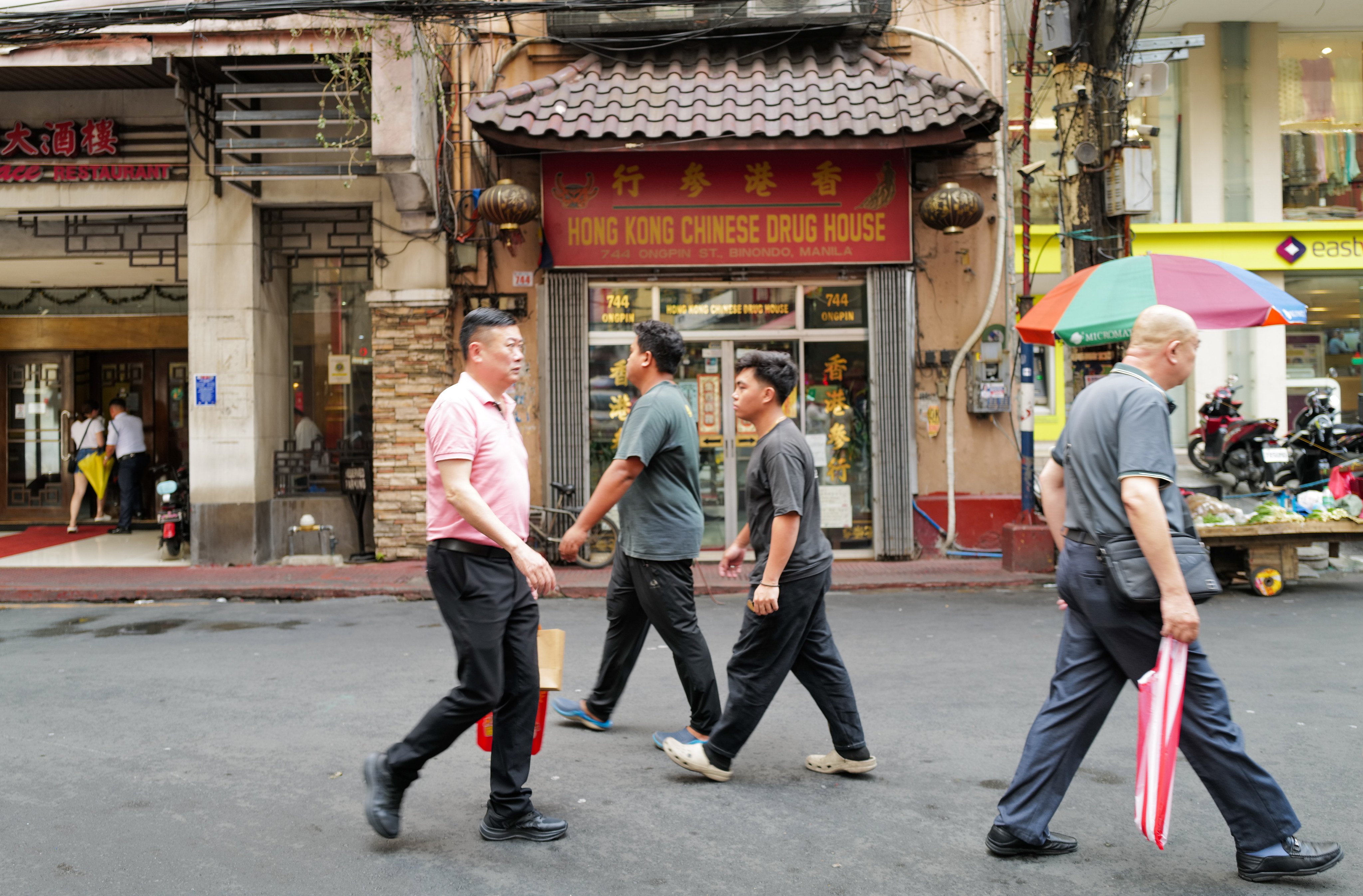 Chinese-Filipinos walk along Binondo in Manila. The community has been involved in disaster relief efforts in the Philippines for many years. Photo: Jeoffrey Maitem