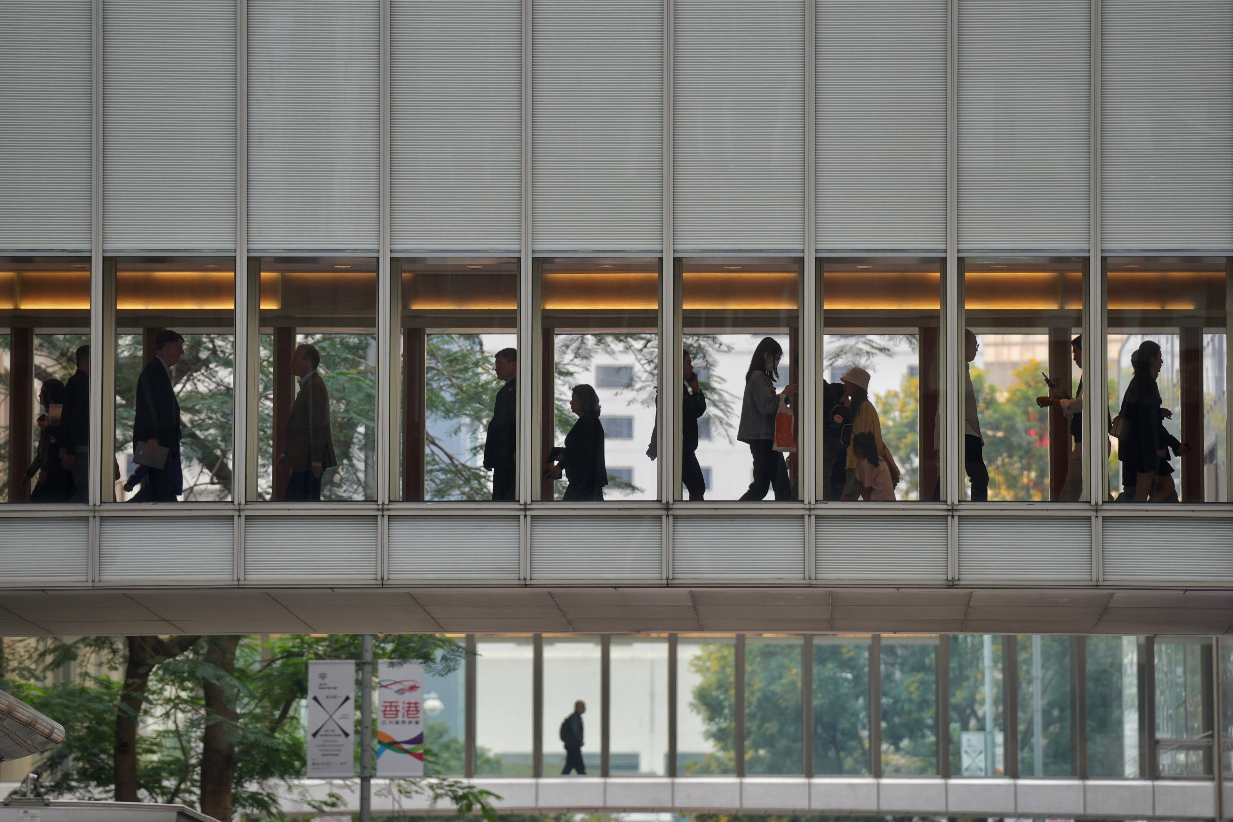 Pedestrians walk on a footbridge in Central. Photo: Elson Li