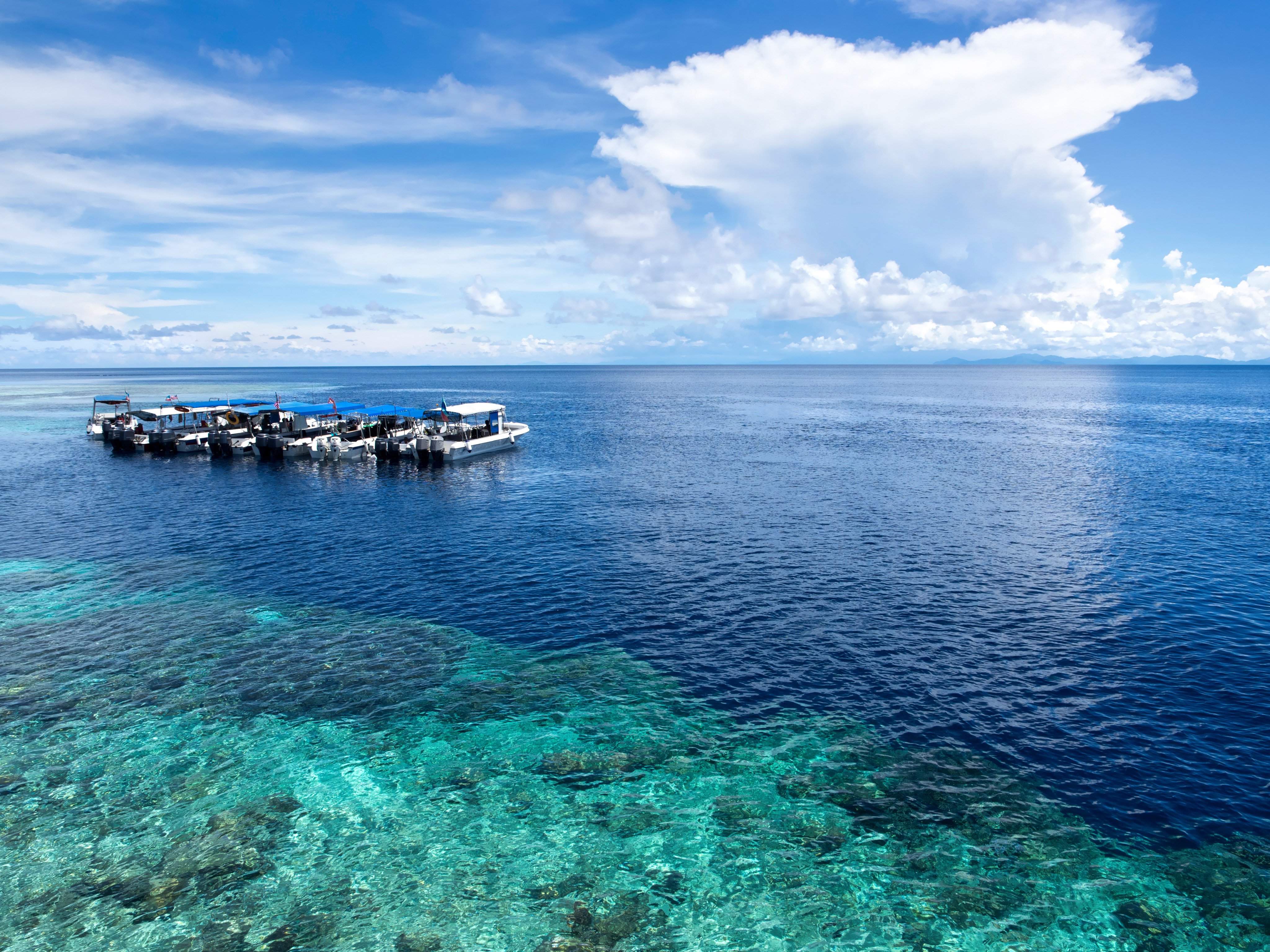 Boats anchor at a dive site off Sipadan Island in Sabah, Malaysia. Photo: Shutterstock