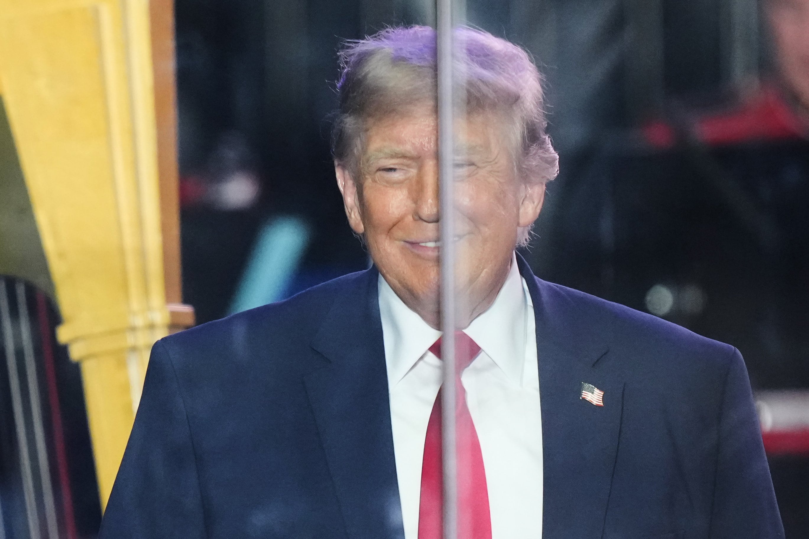 President Donald Trump, protected by bulletproof glass. Photo: AP