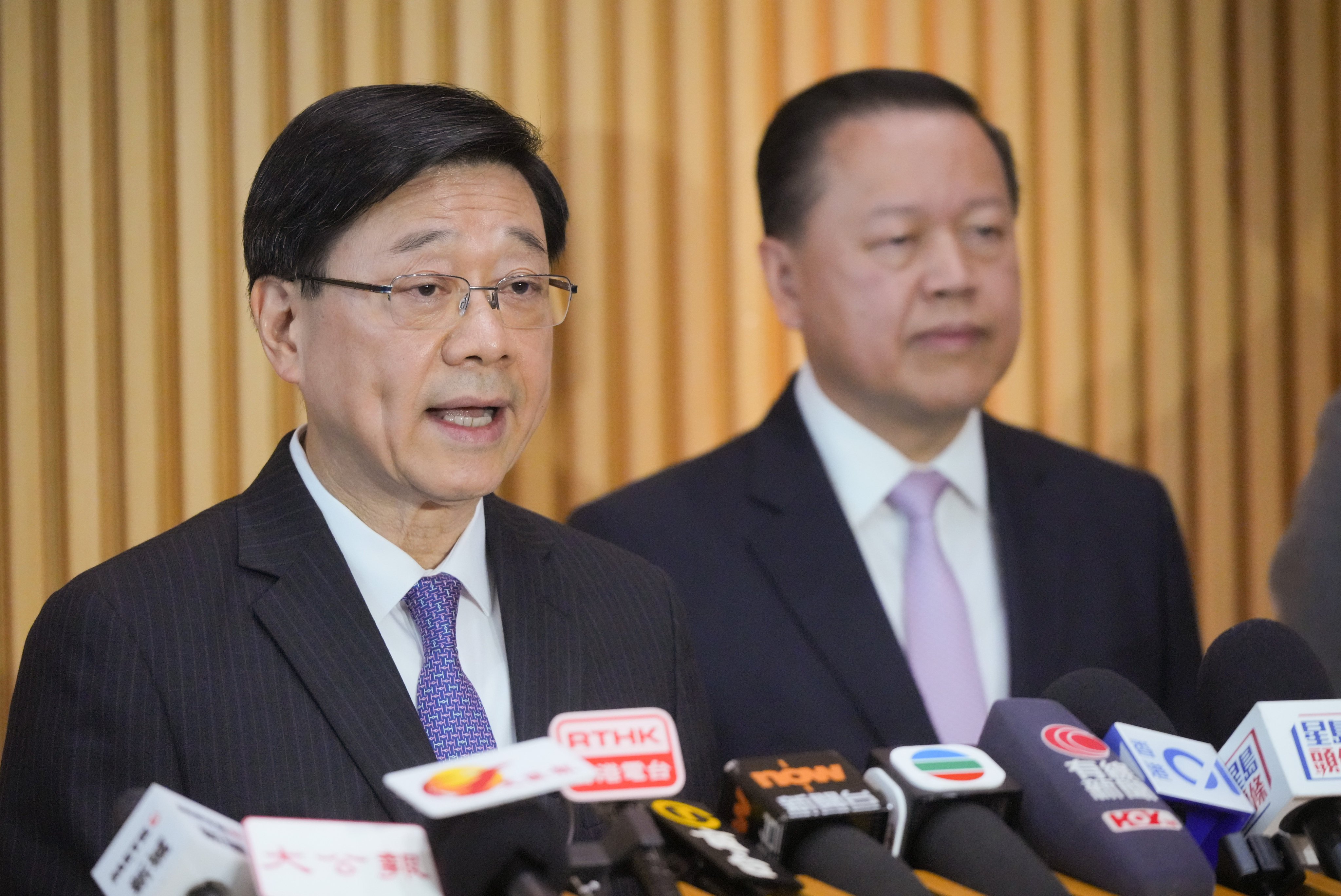 John Lee (left) and University Grants Committee chairman Tim Lui (right). Photo: May Tse