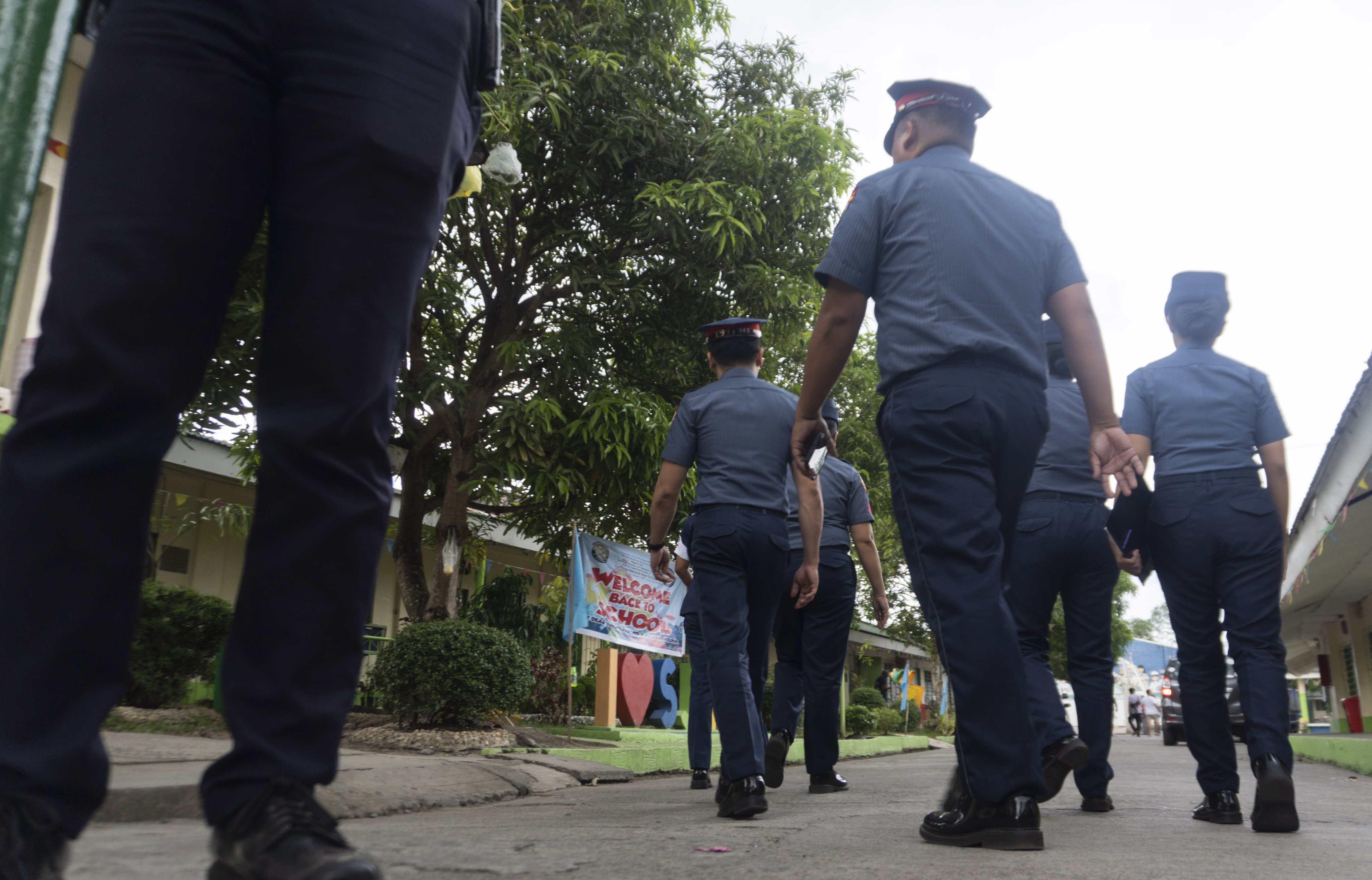 Philippine police officers enter the San Jose National High School in Tacloban City, Leyte province, Philippines, on Monday. Photo: EPA