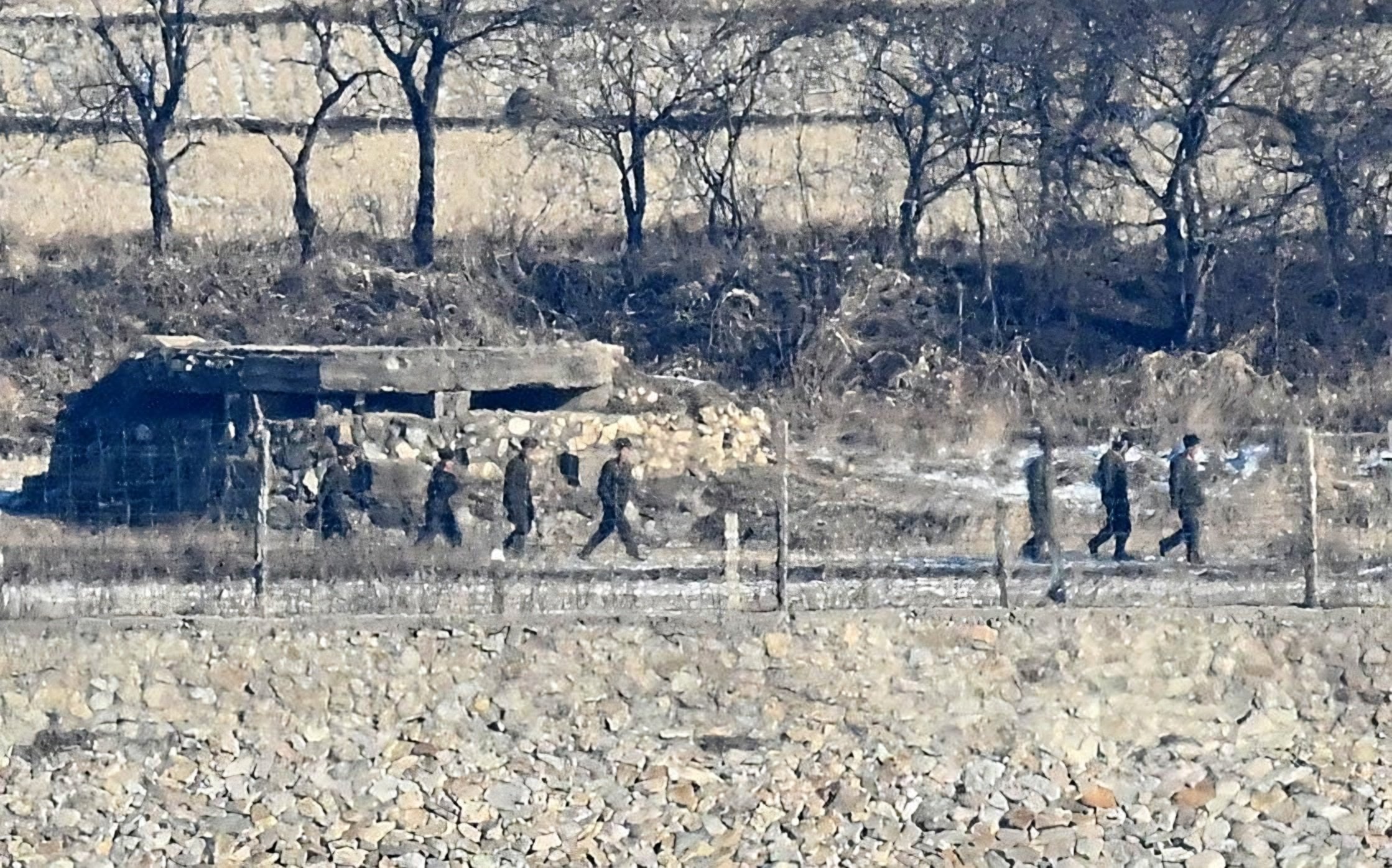 North Korean soldiers move along a fence line near Yujeong-dong village in North Korea, as seen from the Ganghwa Peace Observatory in Incheon in 2024. Photo: The Korea Times