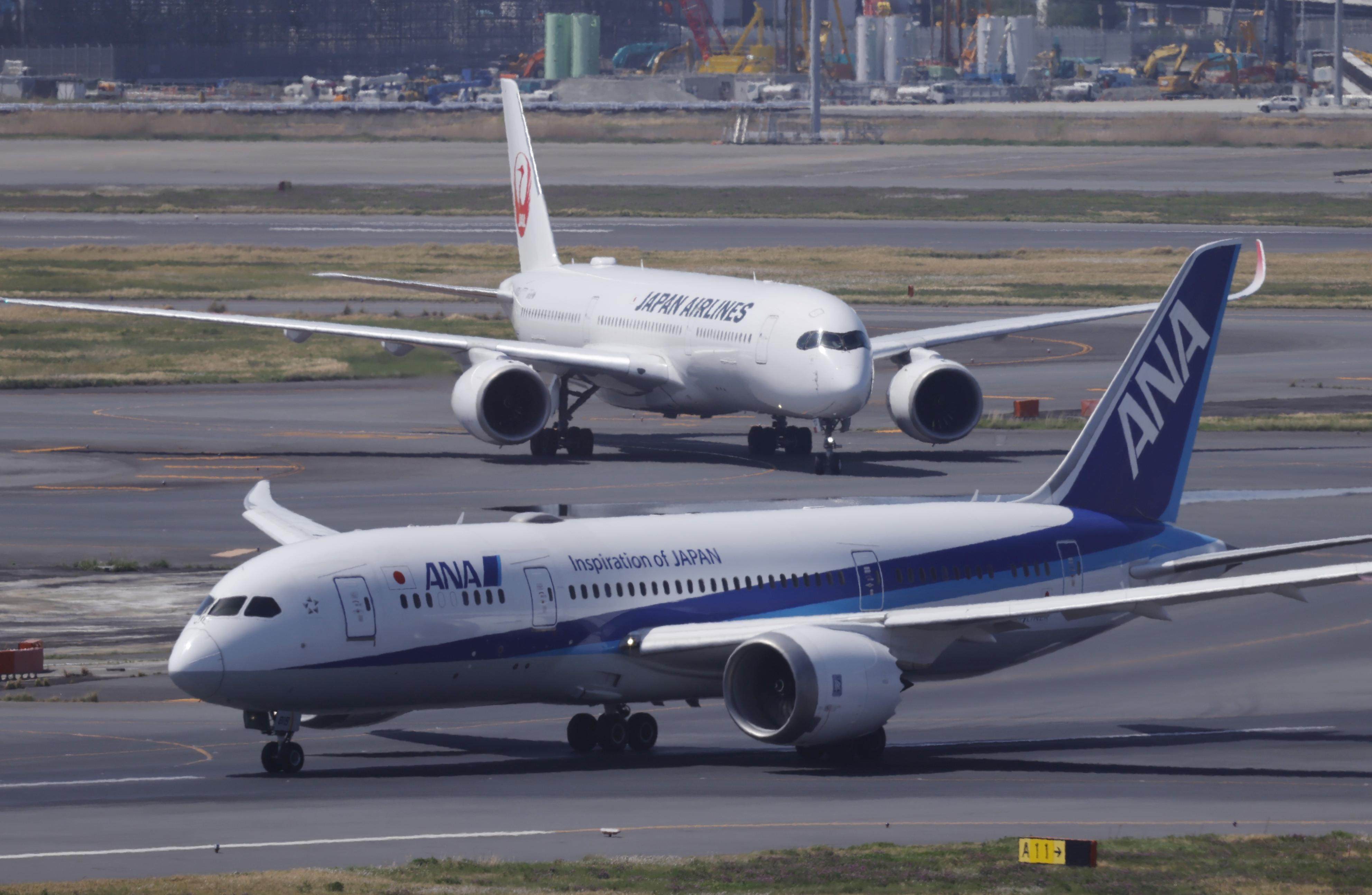 ANA and Japan Airlines planes taxi at Haneda airport in Tokyo on April 12, 2026. Photo: Kyodo