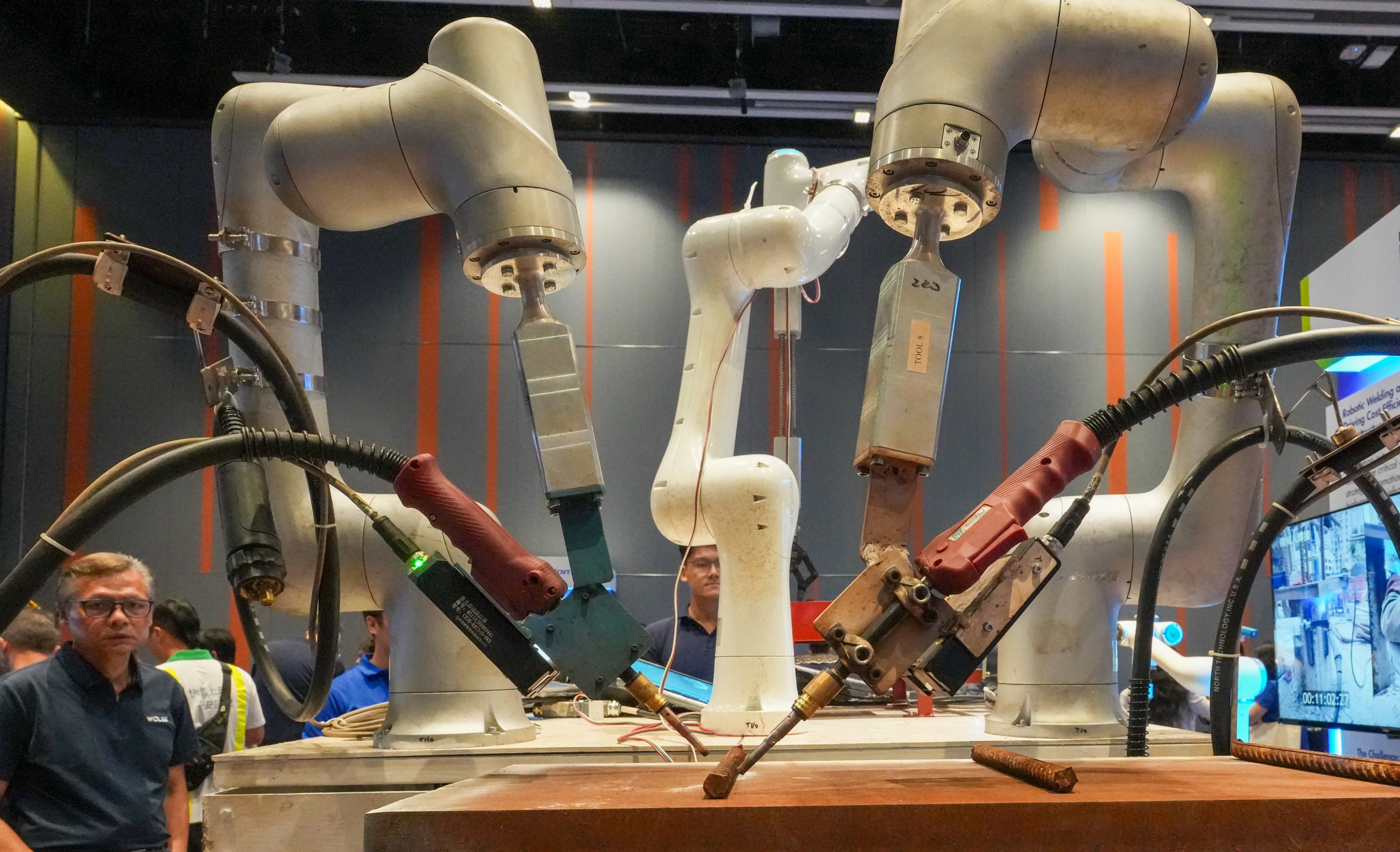 Staff of Wo Lee Capital Holdings conduct a robot demonstration at a construction industry conference and exhibition at the Hong Kong Science Park earlier this week. Photo: Jelly Tse