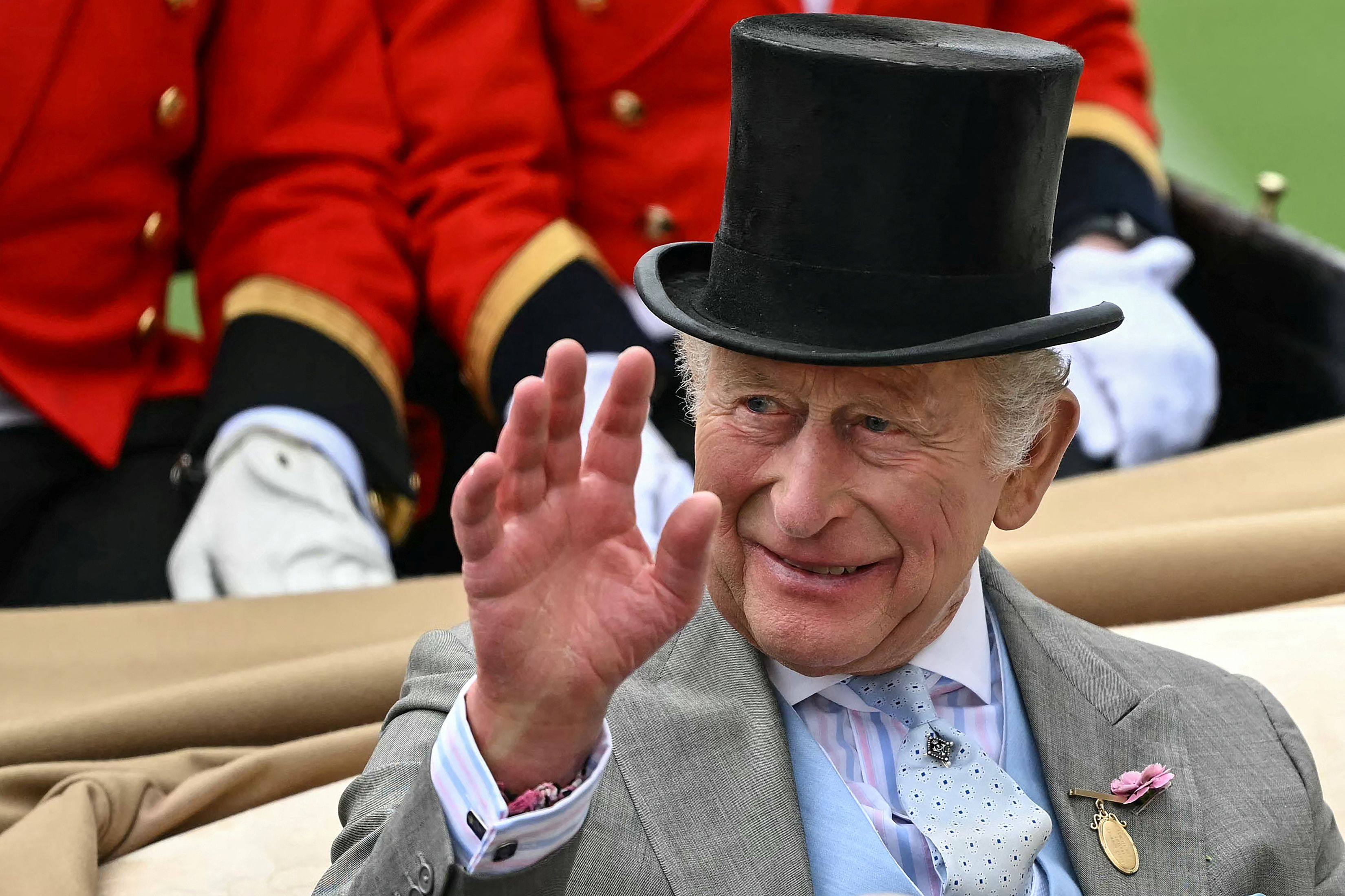 Britain’s King Charles waves as he arrives on the second day of the Royal Ascot horse racing meeting on June 17. Photo: AFP